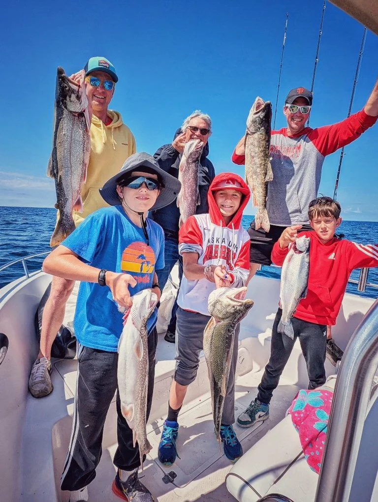 Happy group with a limit of Lake Trout in Oscoda on a Reel Fish'n LLC fishing charter.