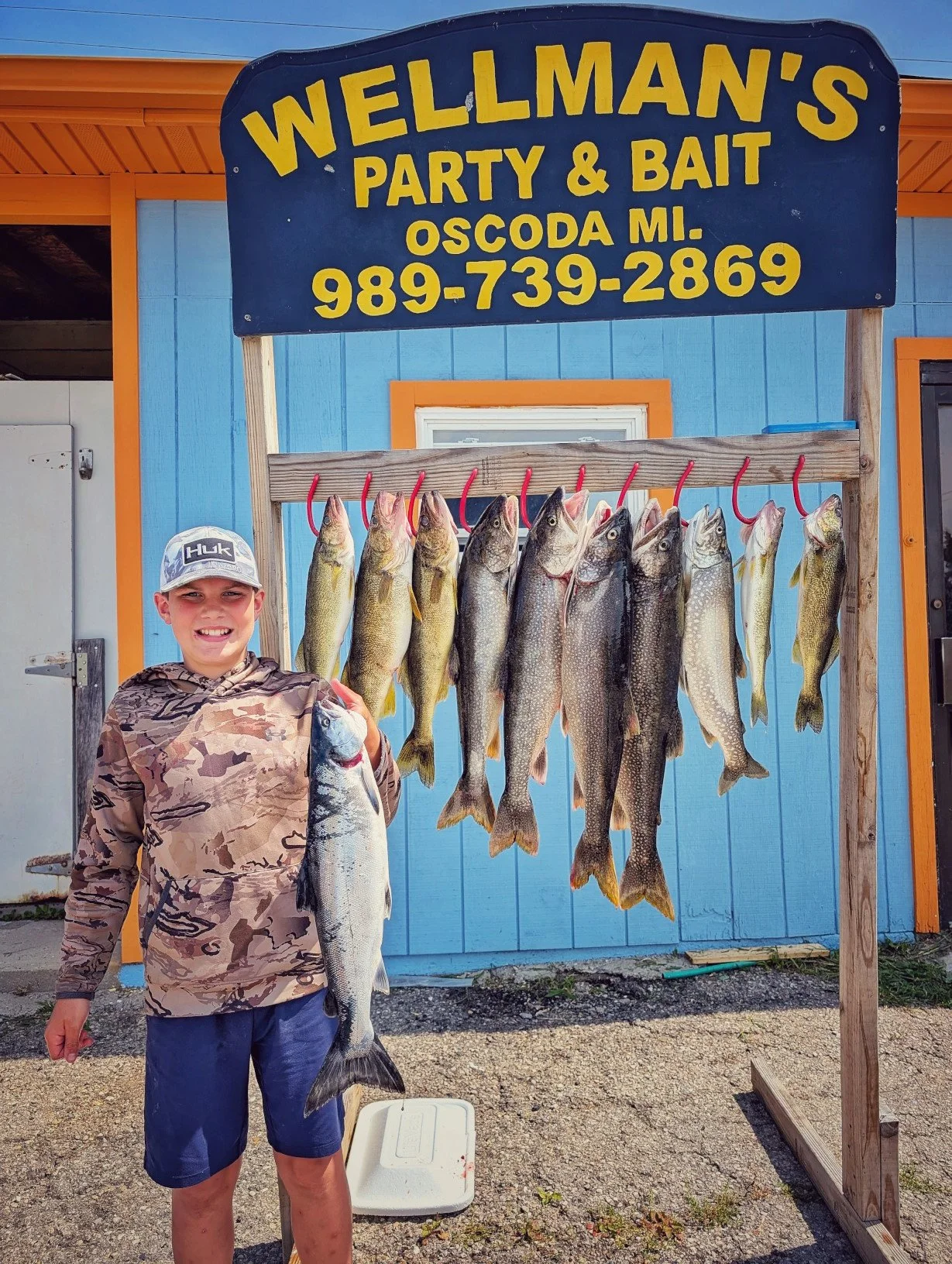 A young angler showing off a trophy walleye caught on a Reel Fish'n family fishing charter.