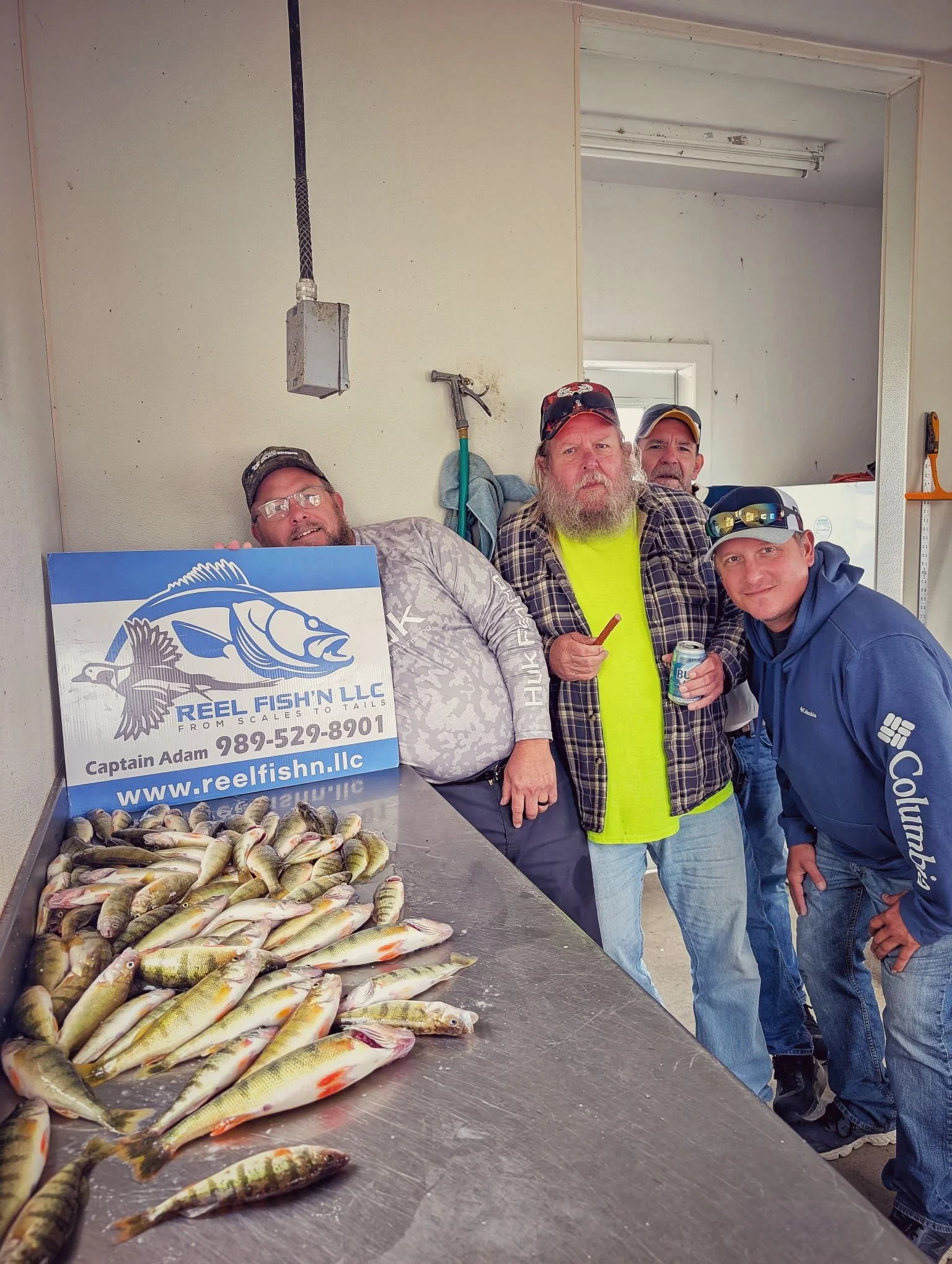 Clients showcasing a full table of eater-sized yellow perch caught on a crisp fall day at Drummond Island with Reel Fish'n, based out of Drummond Island Yacht Haven.