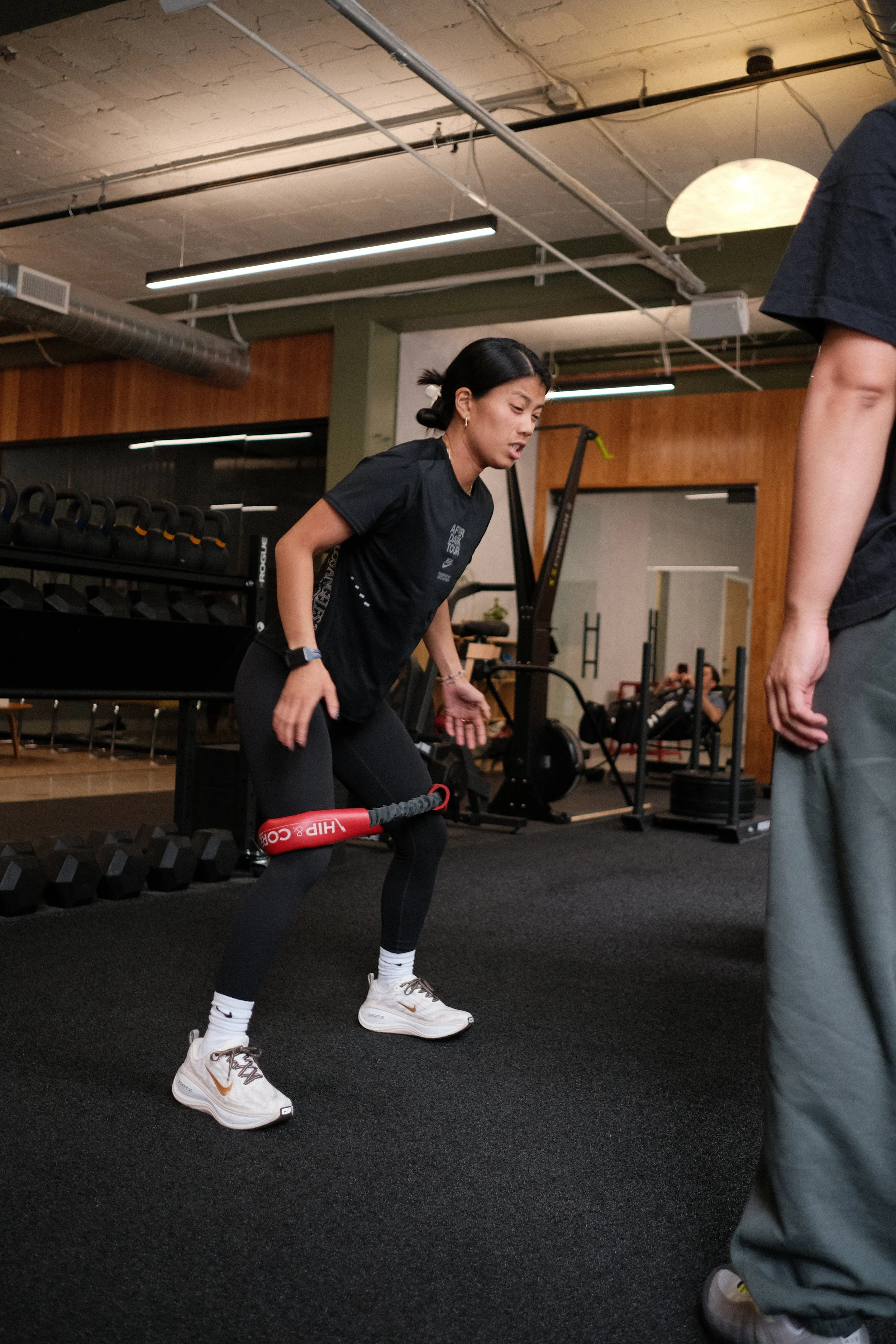 physical therapist guiding runner through gait analysis on treadmill]
