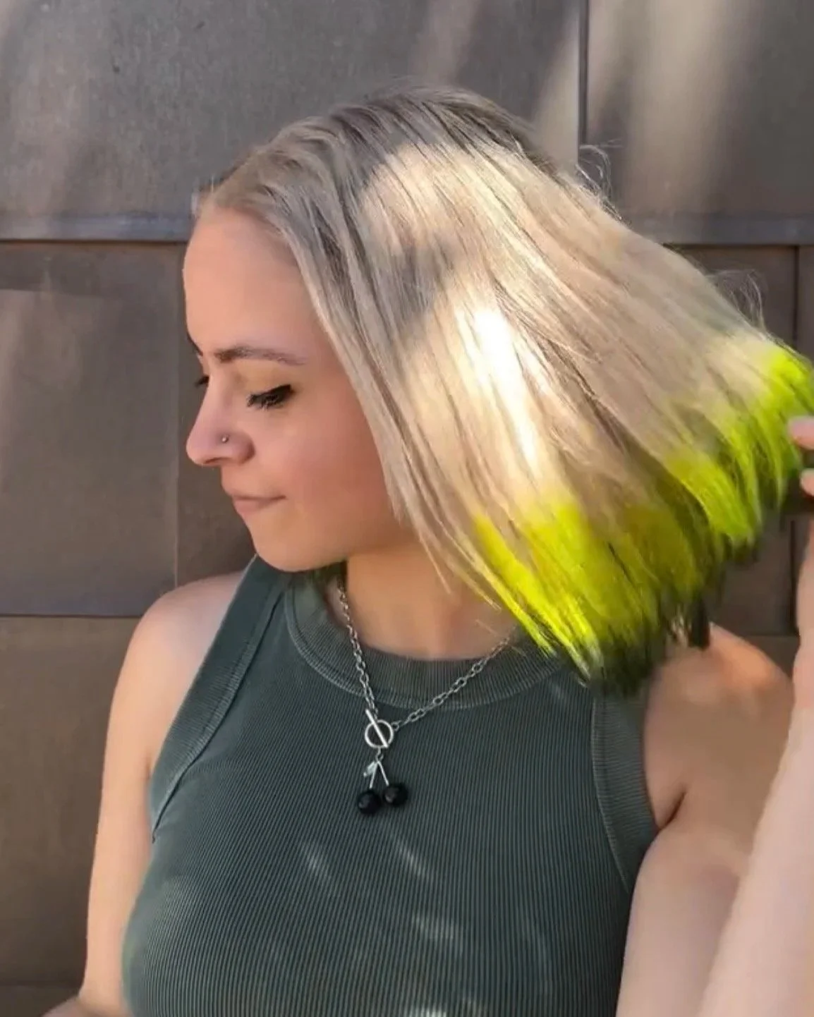 Vivid creative color on blonde hair with bright yellow and black tips