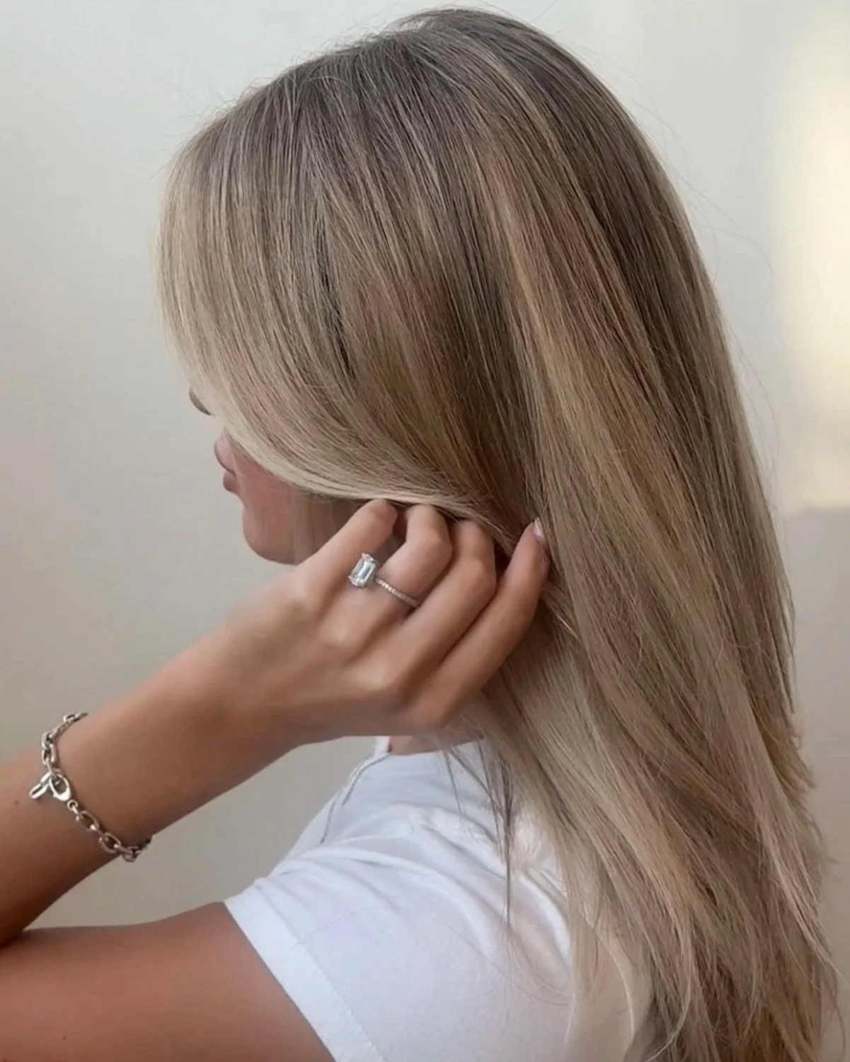 Color melt light blonde highlights on long blown-out hair, Berenices Denver