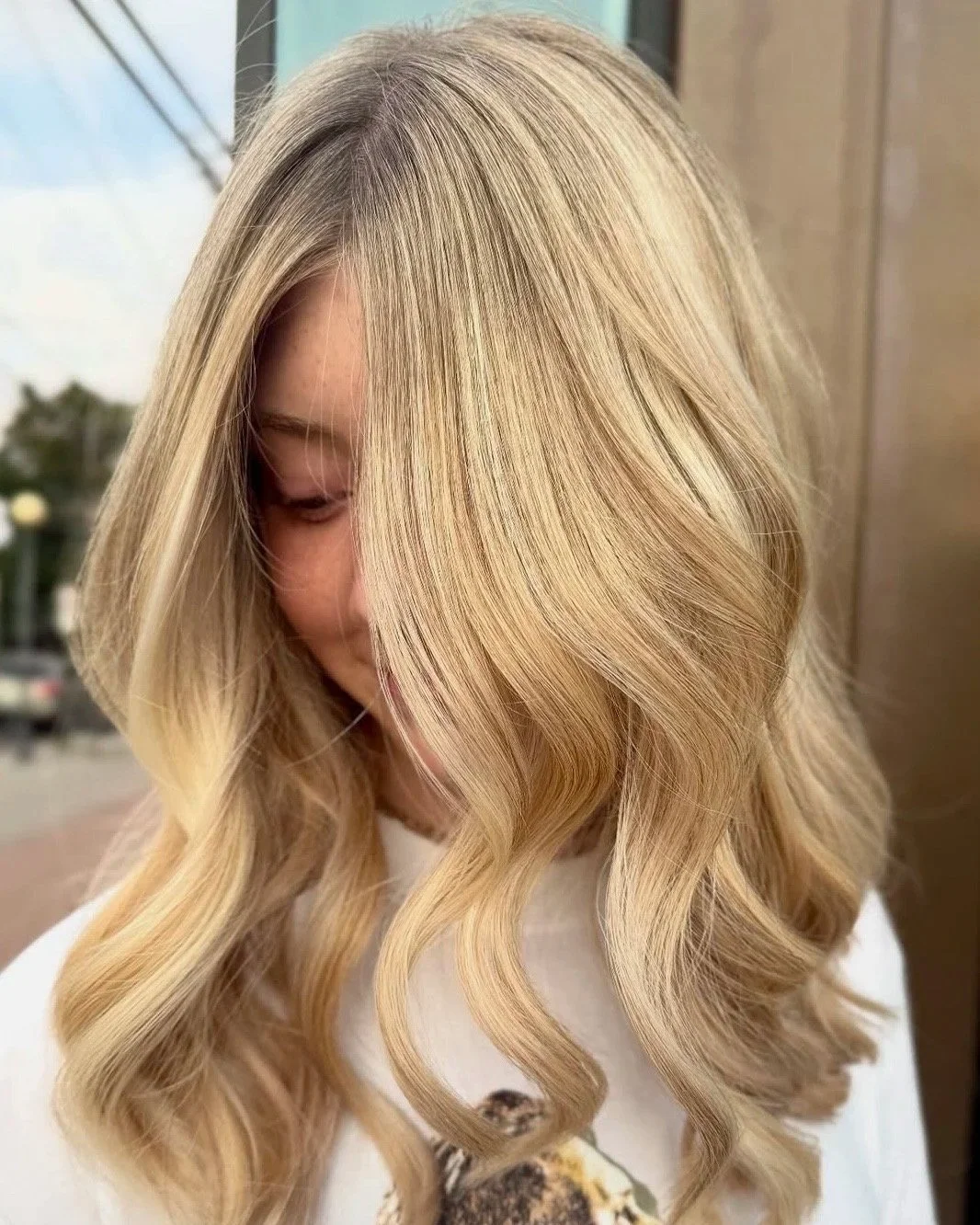 Blonde hair in loose curls with full highlights and toner, by Berenices in Denver