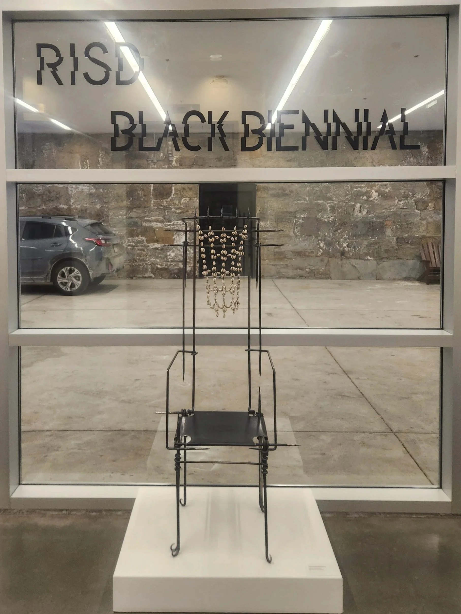Final iteration of chair adorned with cowrie shells on view at the 2026 Black Biennial at RISD