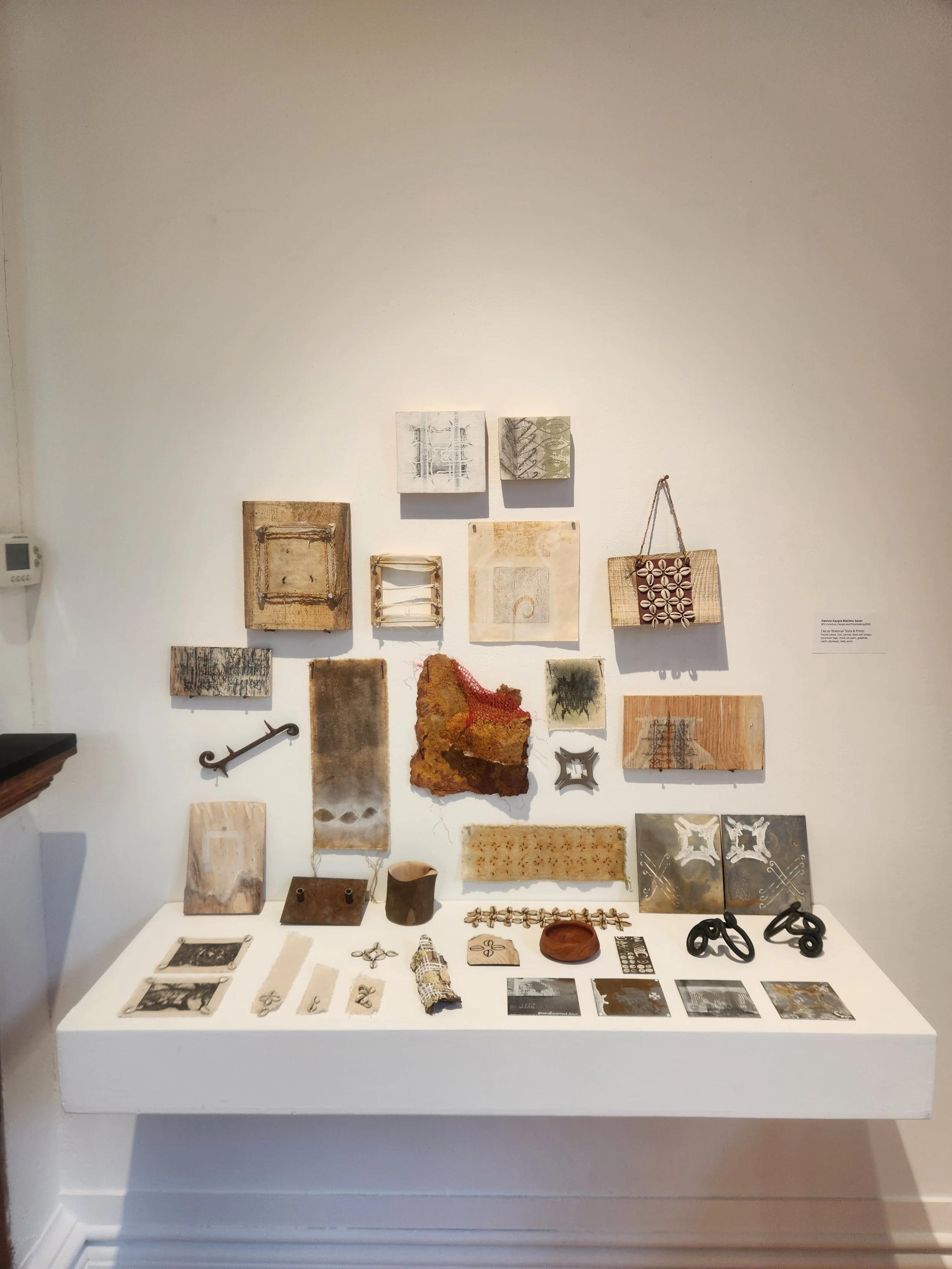 Small Prayers (Material Decay Tests). 2025-2026. Mild steel. Vinegar. Salt. Rust. Copper oxide. Kenyan cowrie Shells. Black and white pigments. Various found pieces of wood, leather, bark, and fabric.