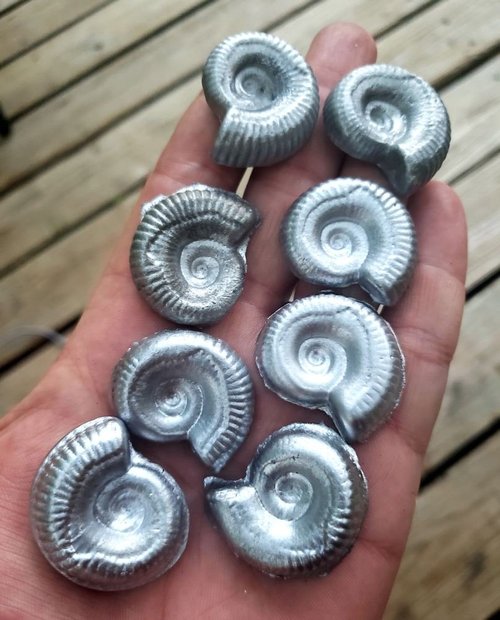Handful of cast silver ammonites