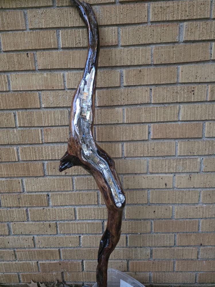 Silver-finished driftwood against brick