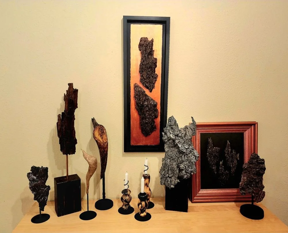 A collection of sculptures and framed pieces displayed together