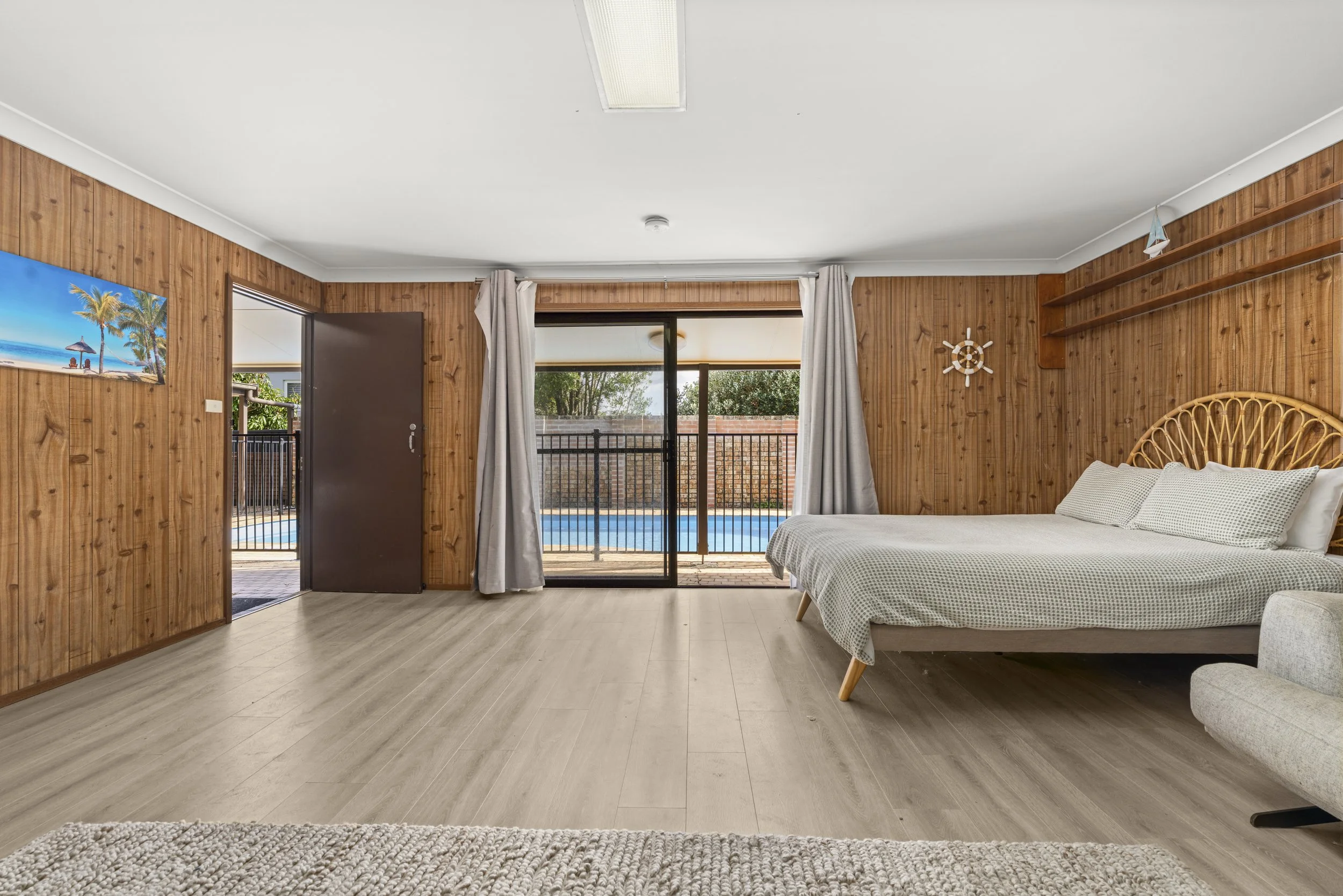 Stylish, self-contained pool house featuring a bed and kitchenette, combining comfort, privacy, and easy pool access.