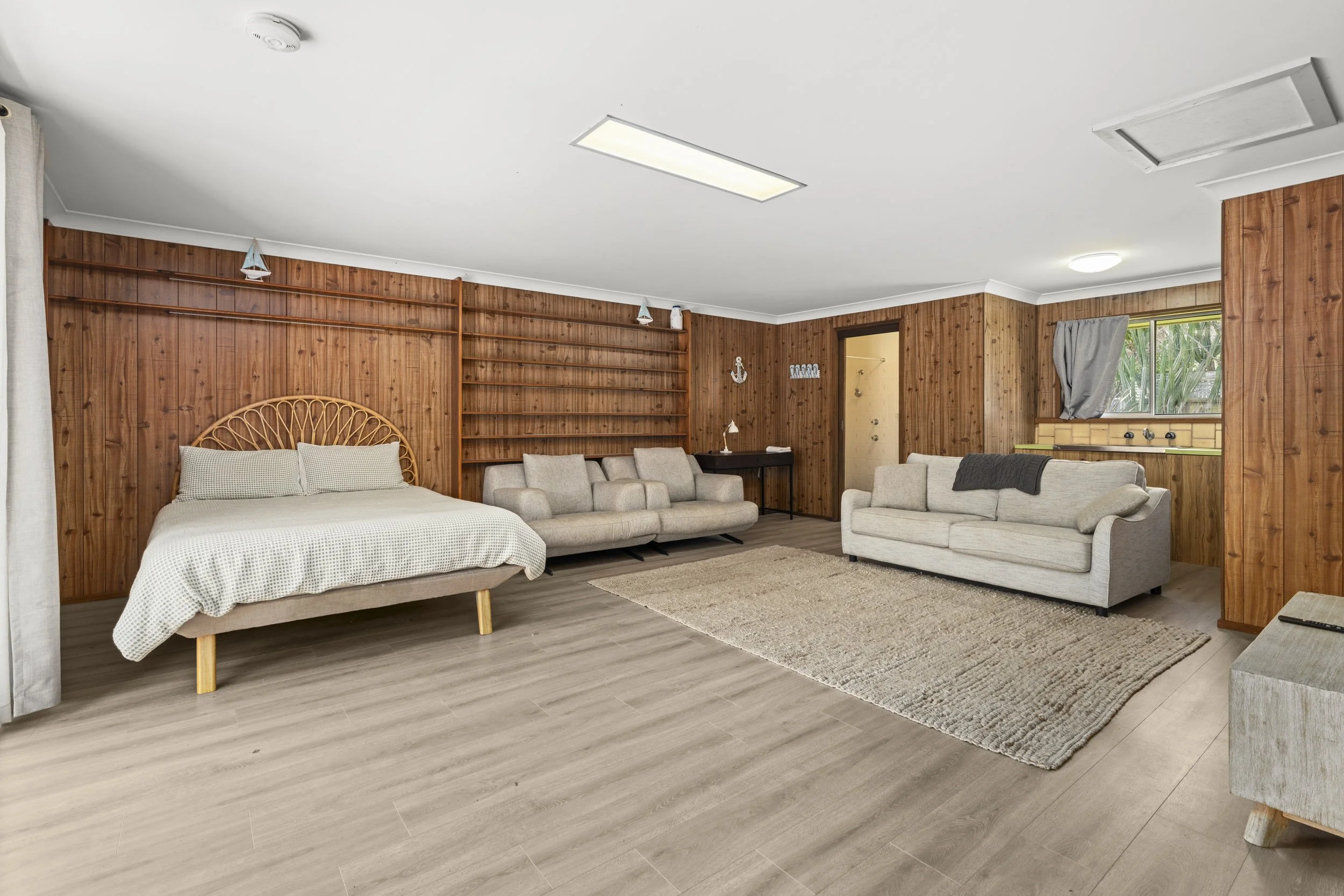 Self-contained pool house featuring a bed and kitchenette, combining comfort, privacy, and easy pool access.