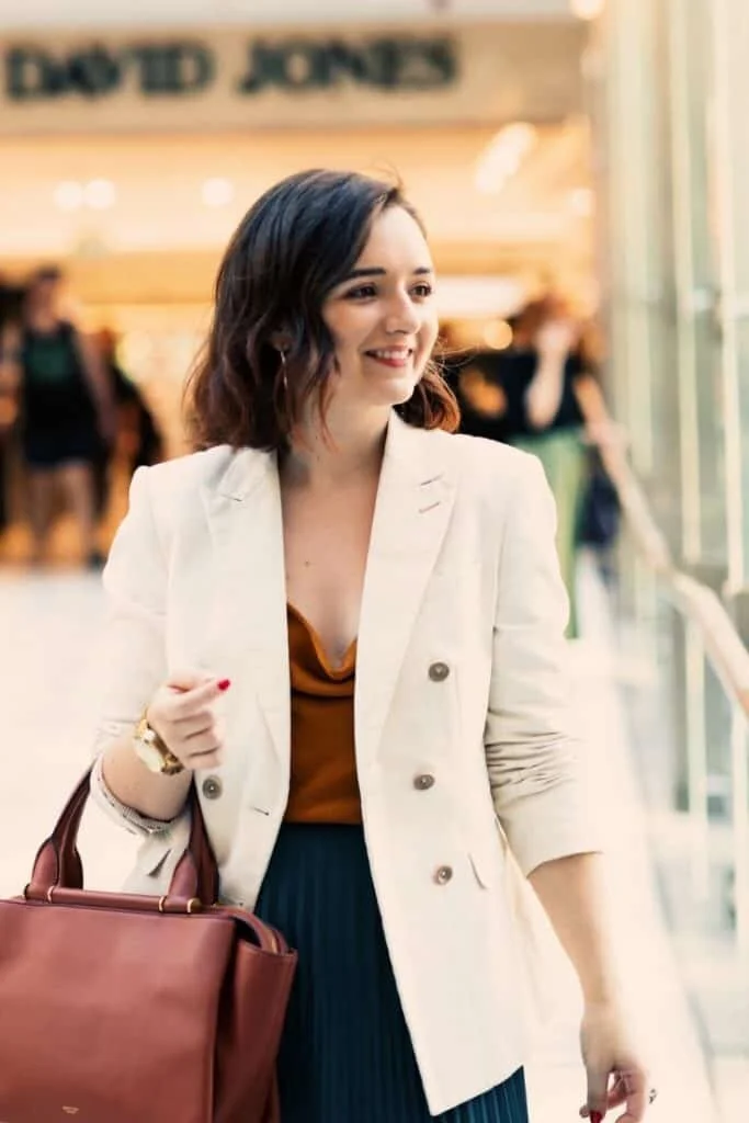 Alarna Hope shopping in David Jones in Sydney City wearing white stylish blazer and leather handbag