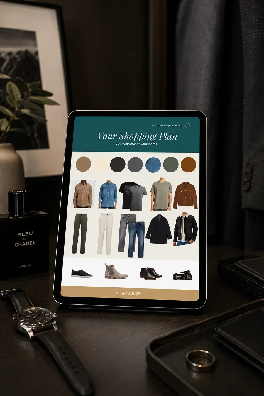 iPad displaying a personalised men's wardrobe shopping plan on a dressing table with men's accessories, showing a custom colour palette and recommended clothing for a smart casual capsule wardrobe.