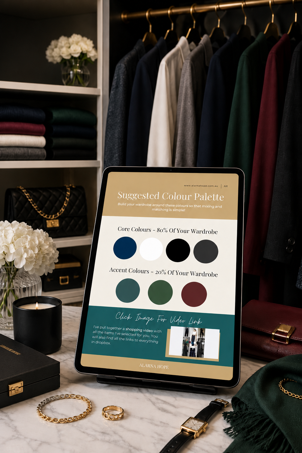 Wardrobe Makeover colour palette guide shown on an iPad beside women’s clothing in black, navy, charcoal, forest green and wine red.