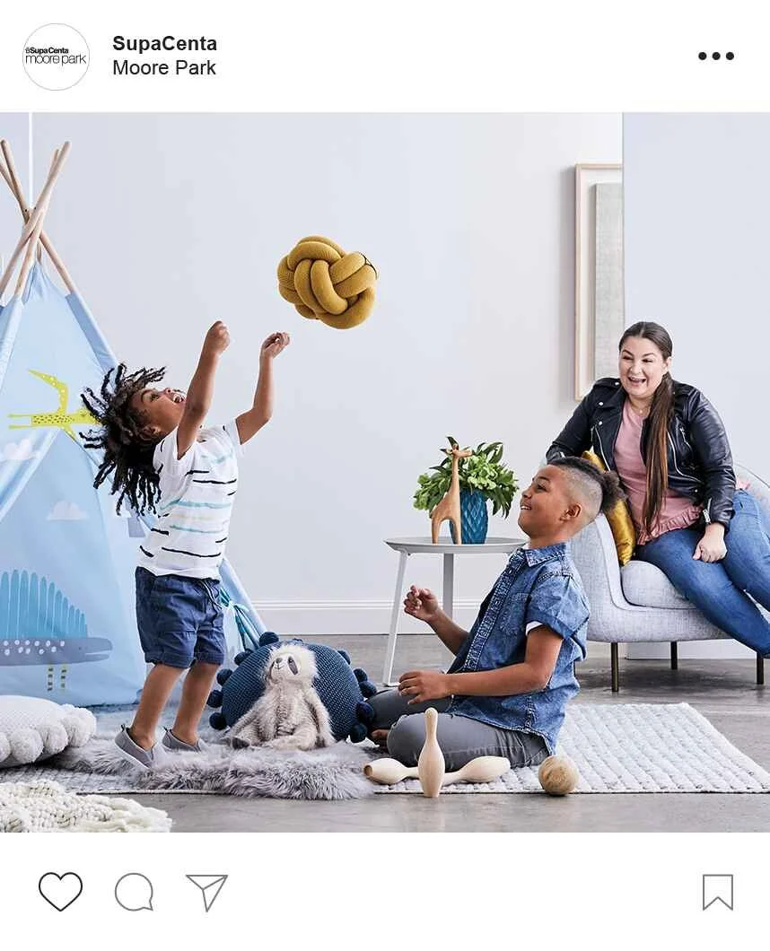 Fashion Stylist for advertising work showing family playing in a loungeroom.