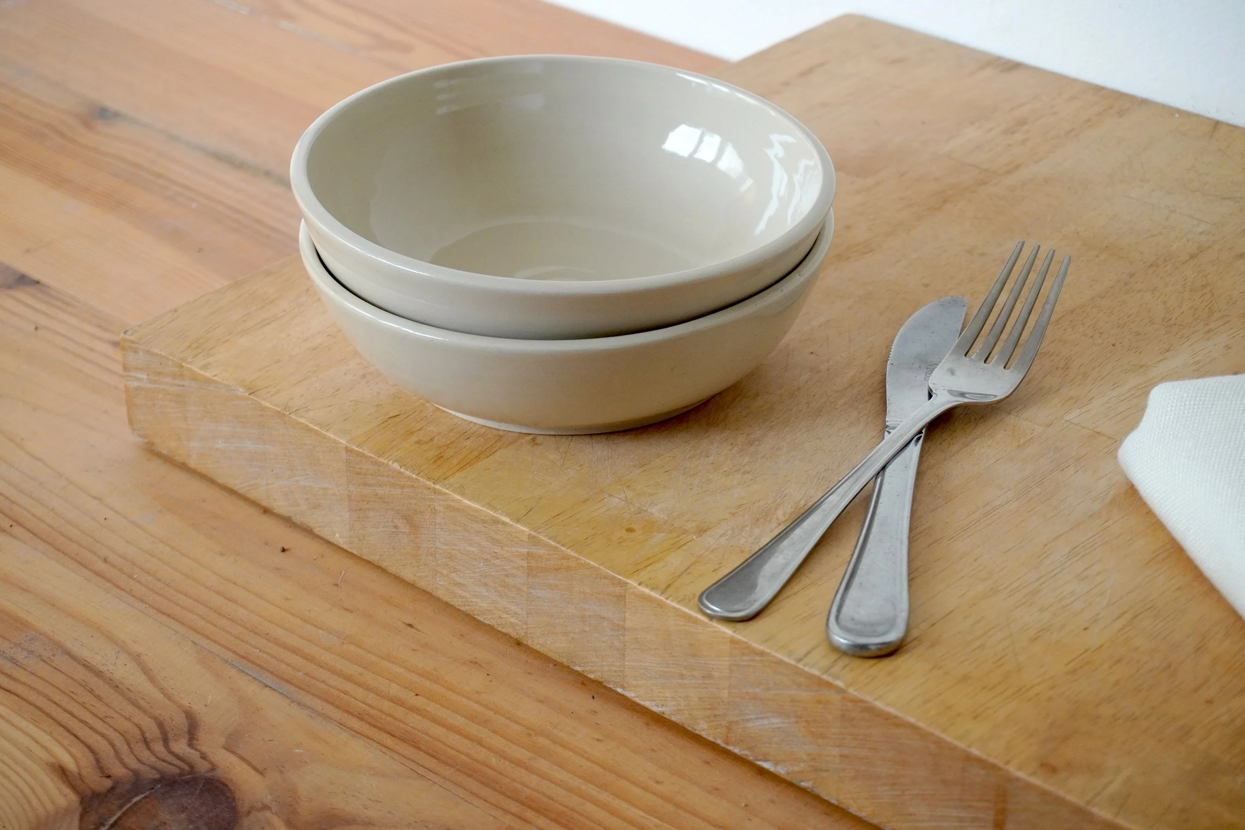 The two salad bowls with a knife and fork for scale