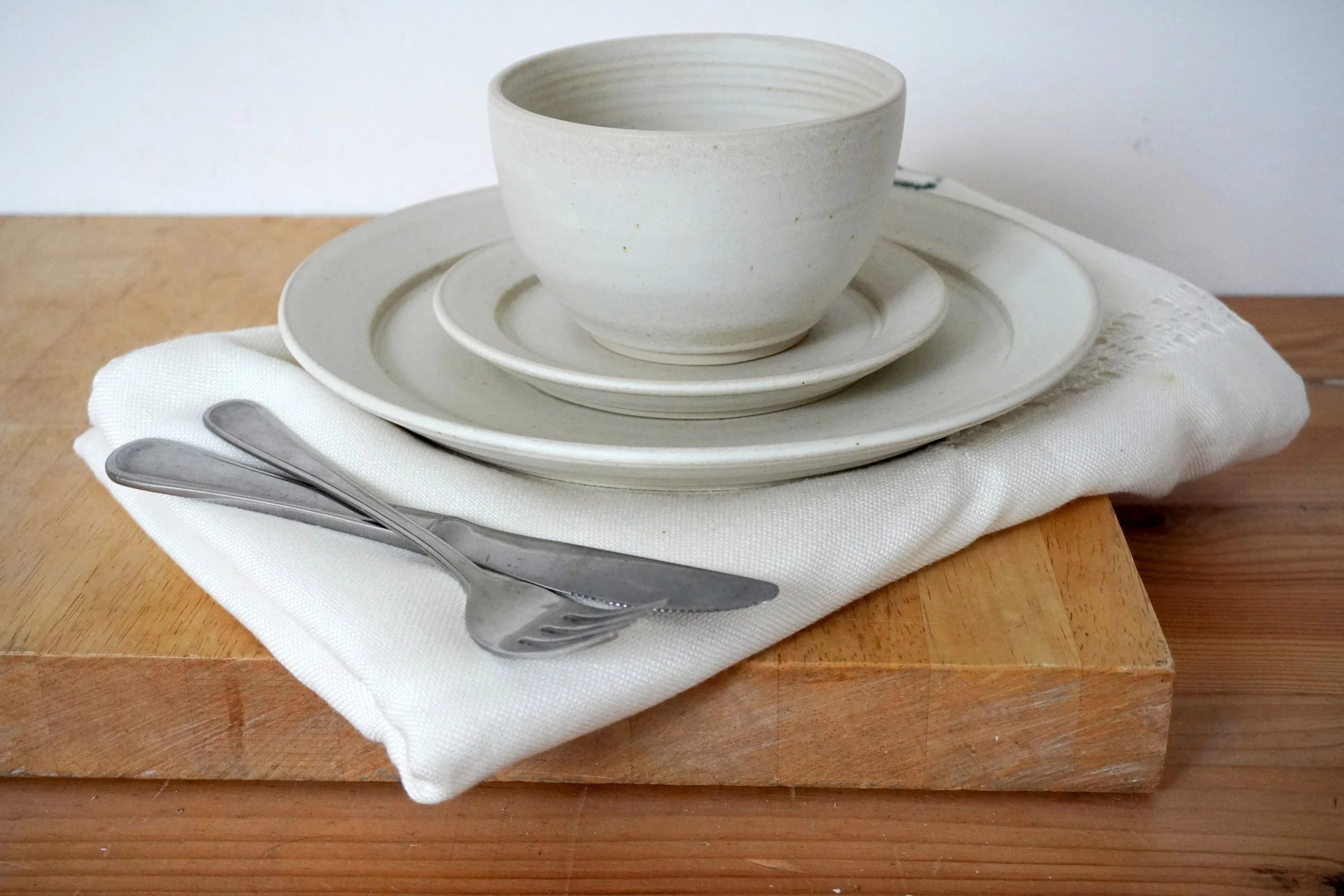 A single place setting with a knife and fork for scale