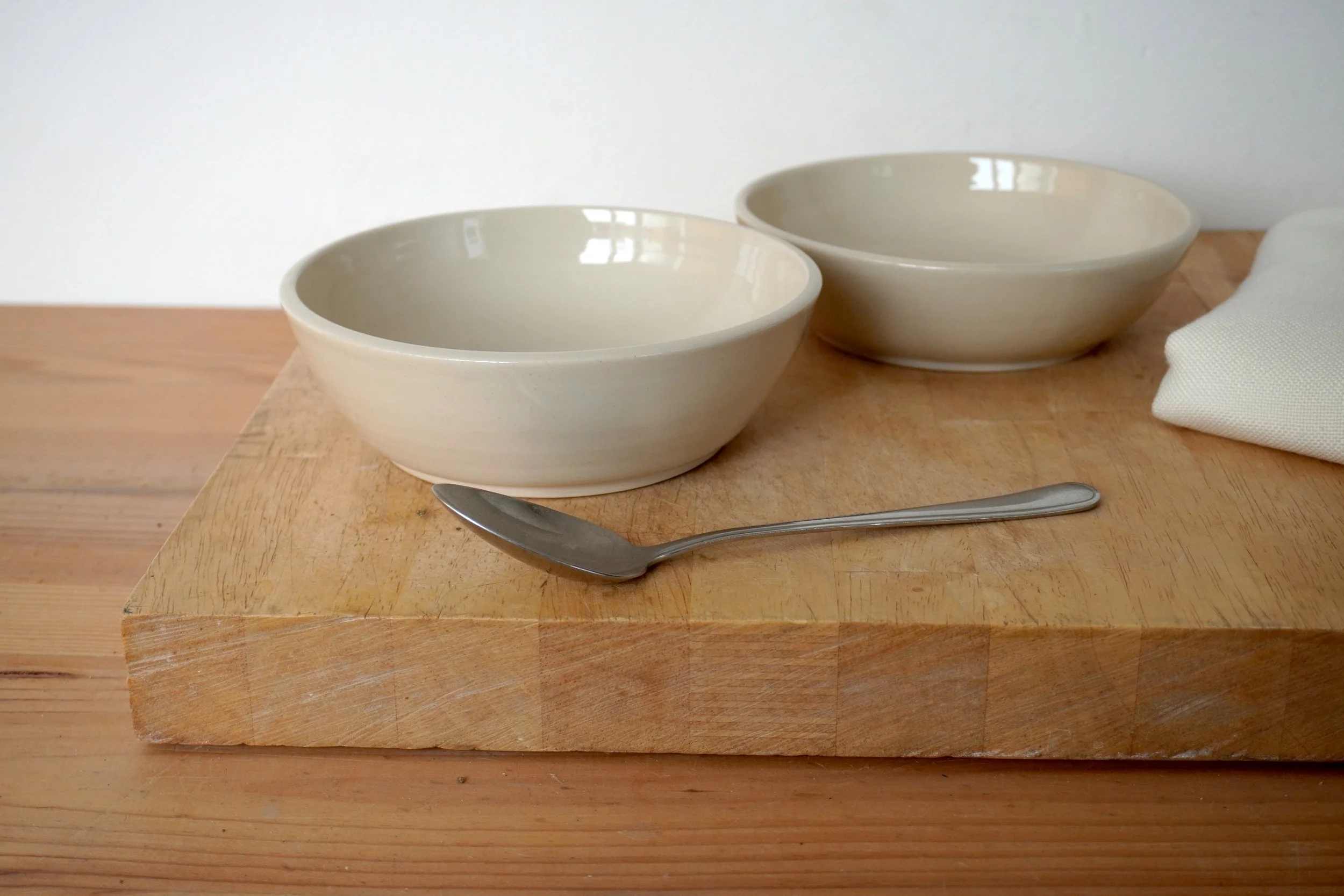 The salad bowls photographed with a tablespoon for scale