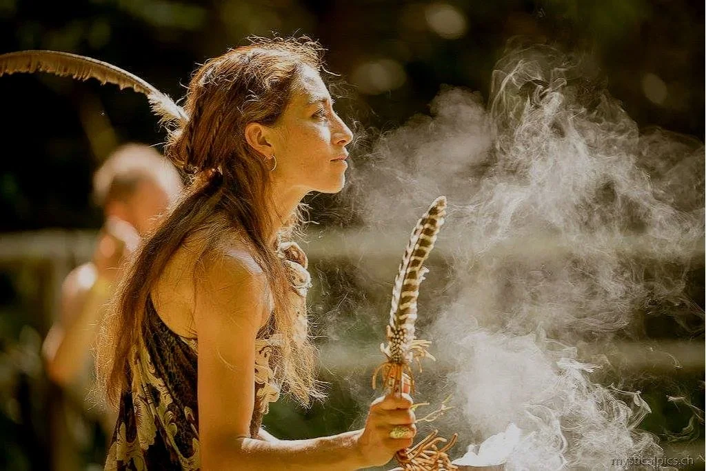 Shaman, medicine woman, during an outdoor ceremony.