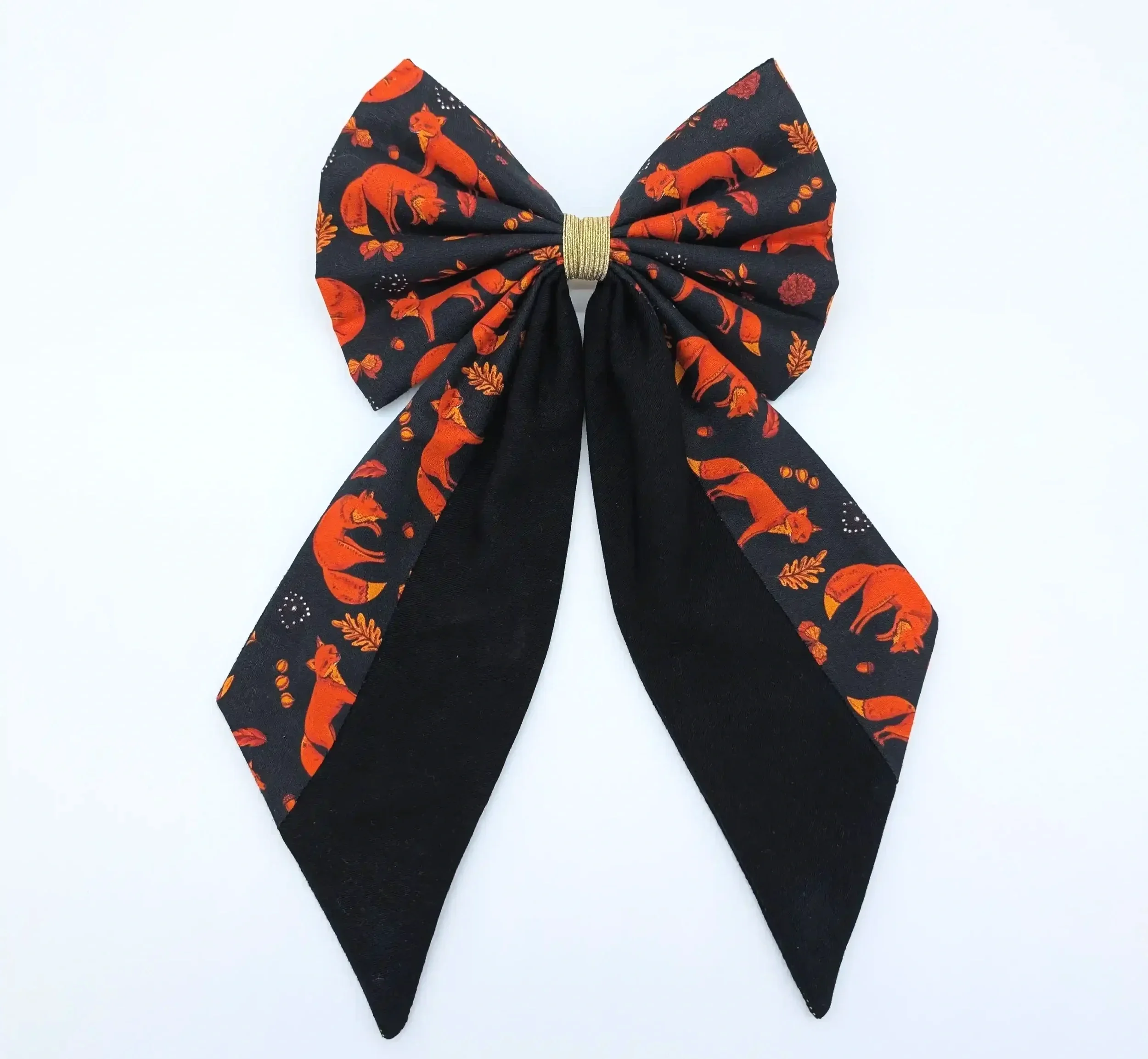 Grand nœud pour cheveux Renards taille XL, avec longues pointes noires, motifs de renards roux et finition centrale dorée.