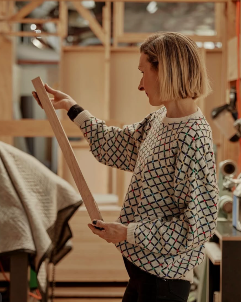 Em from By Dave in the workshop, examining table components. Shot for Broadsheet Melbourne.