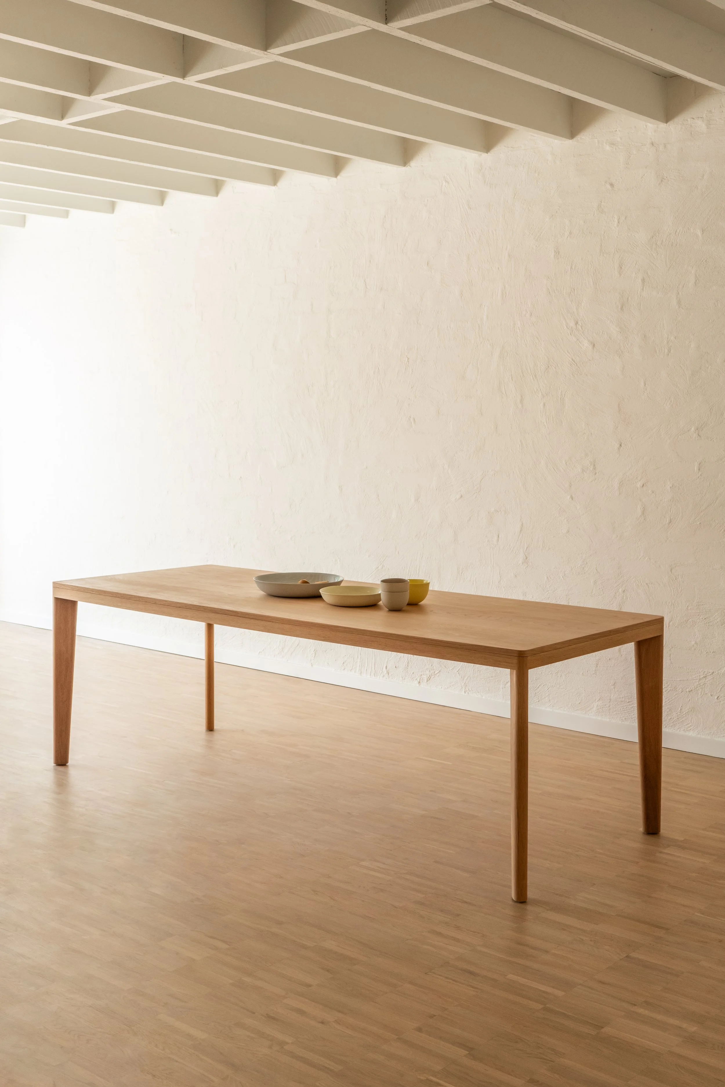 Dining room styled with a By Dave Everyday table, with Mud Australia ceramic dishes on the table.