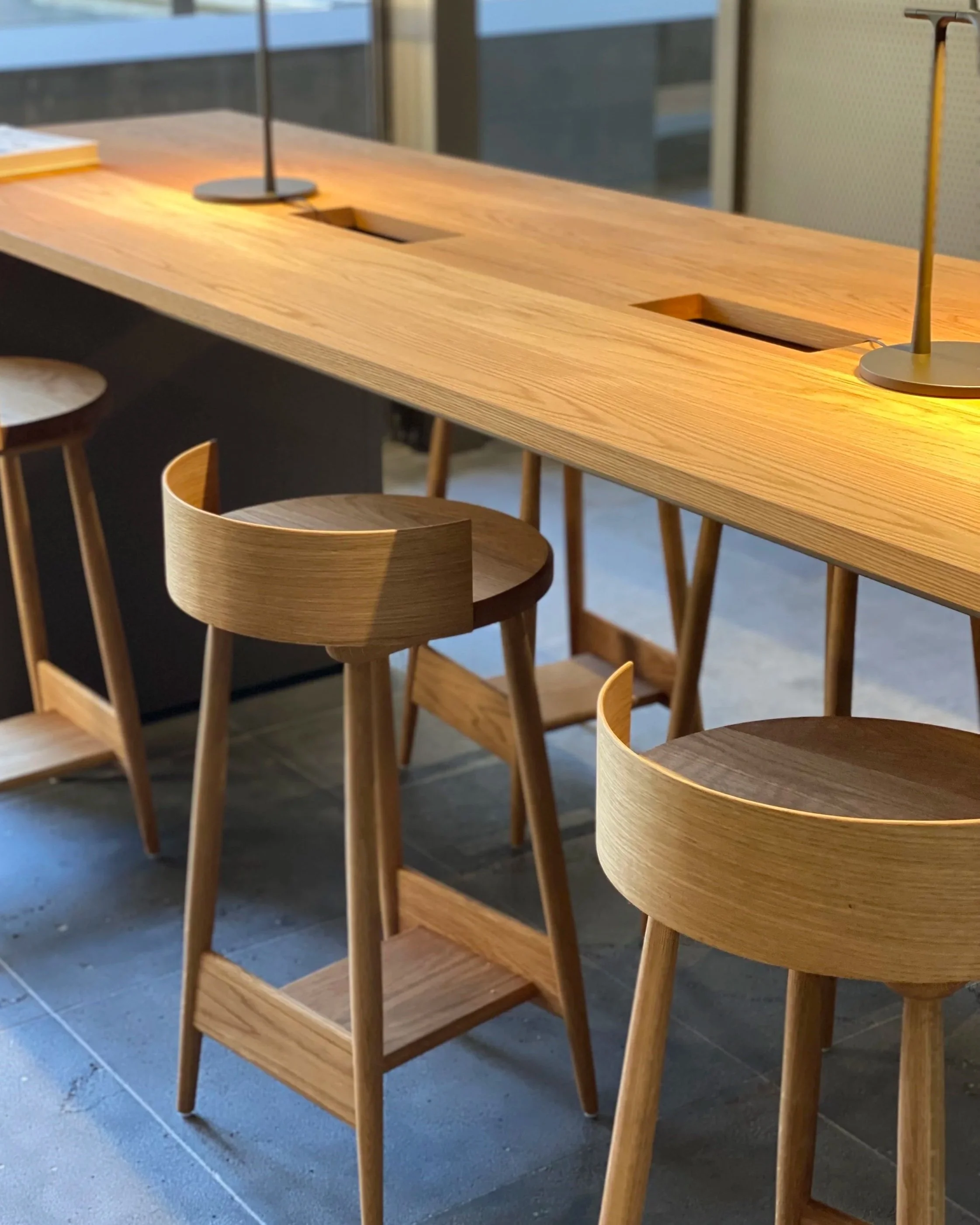 Interior view of NGV staff space showcasing American Oak work benches, and custom designed and made curved back stools.