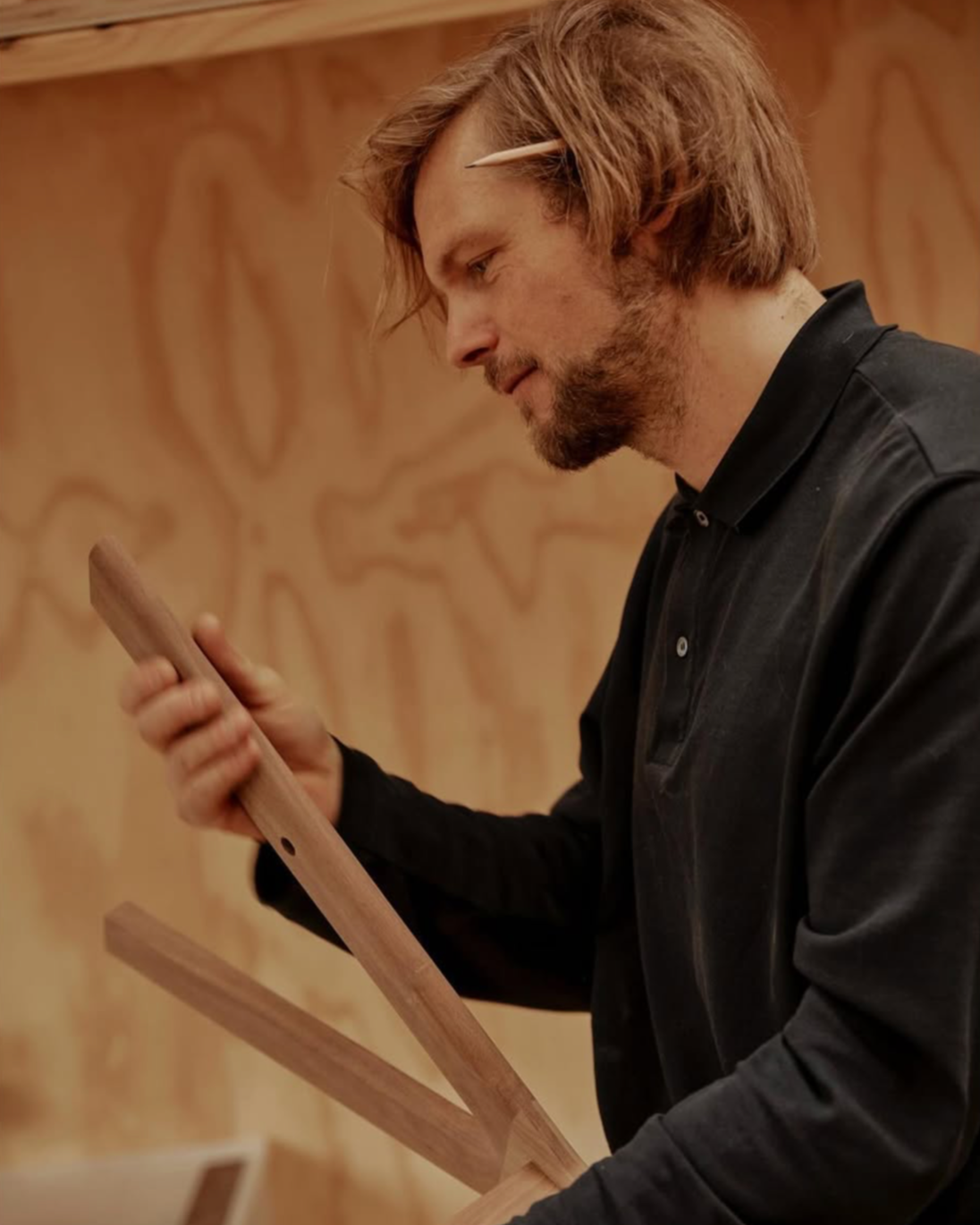 Dave from By Dave examining components of the E1 Chair in Walnut.