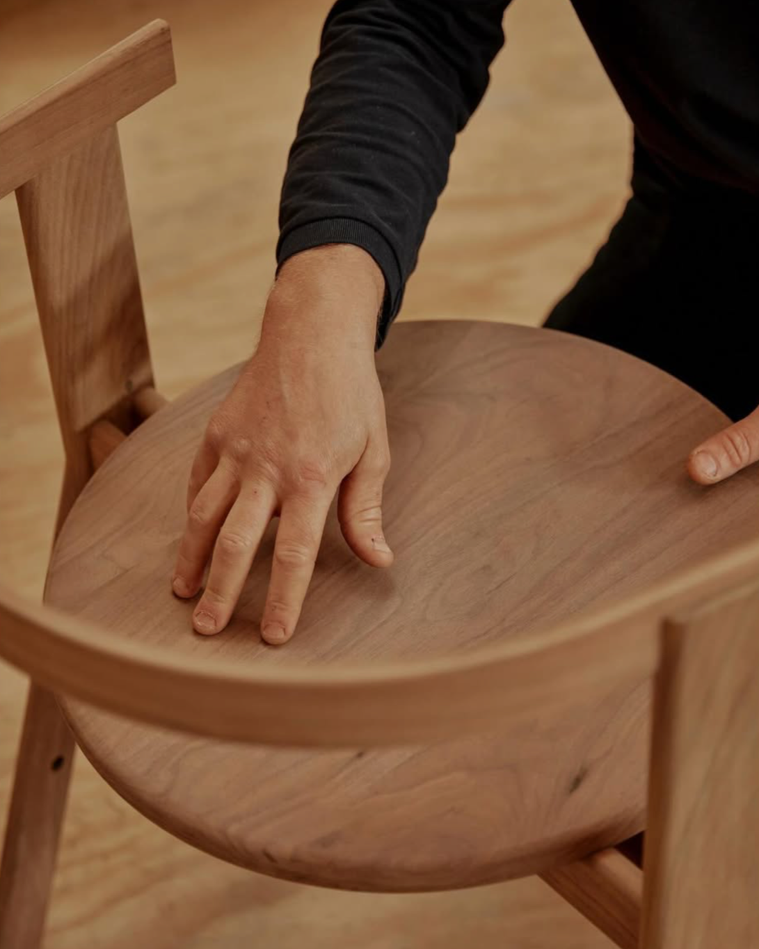 Dave from By Dave inspecting the E1 Chair in American Walnut.