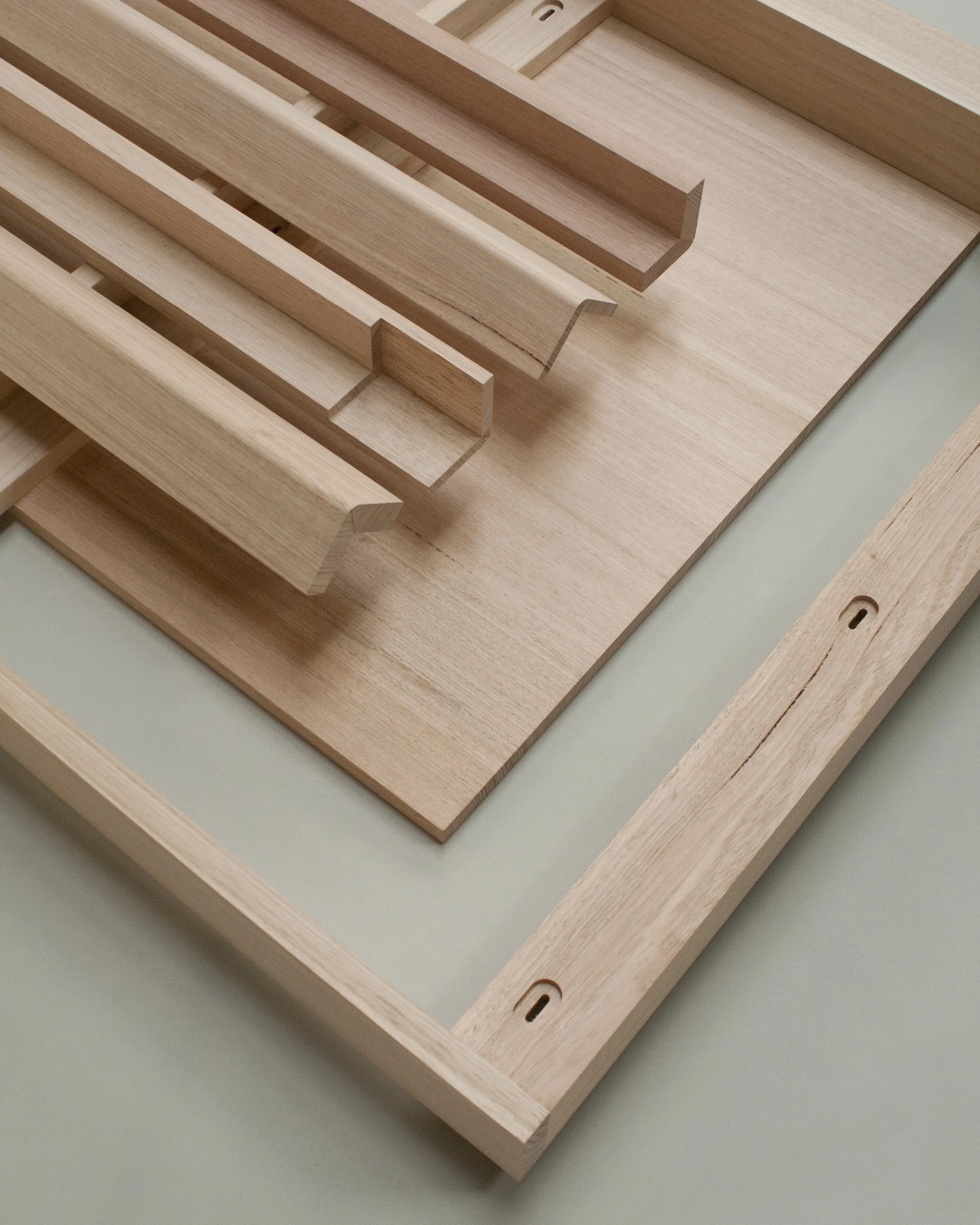 Various wooden components of custom By Dave table , including slats and a frame.