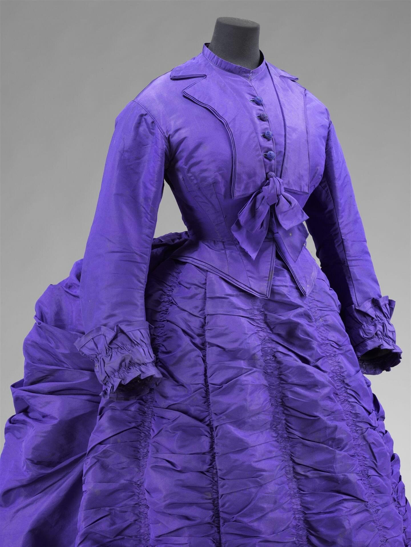 💜 &ldquo;The ruched skirt and draperies on this dress reverberate with intense colour, revealing the fashion for bright new synthetic dyes. Their inception owes much to the work of Sir William Henry Perkin (1838-1907), who discovered the first famou