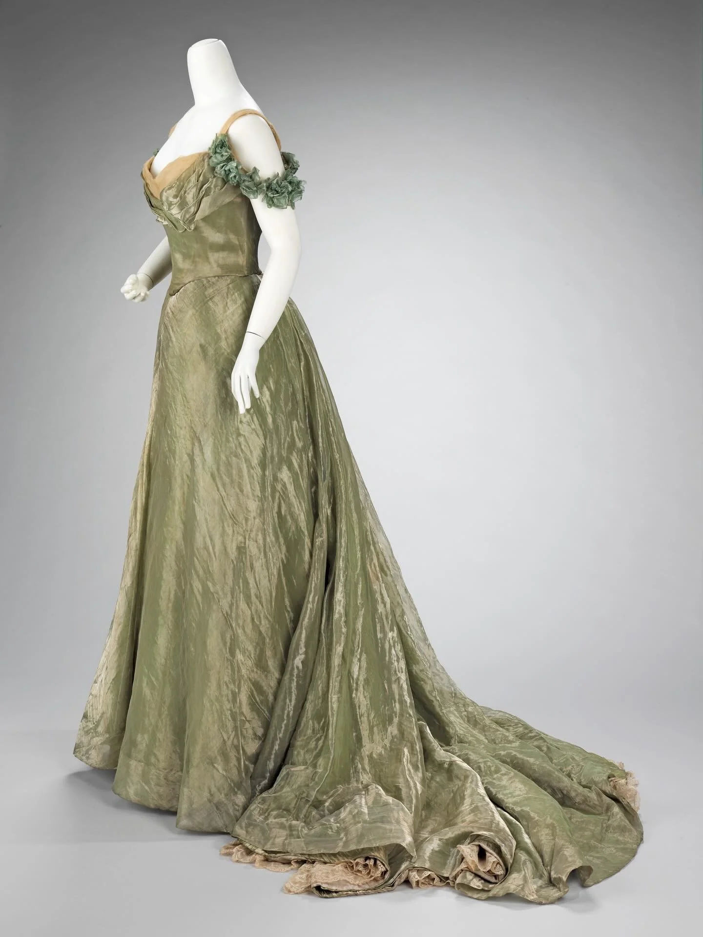 🌿 &ldquo;This ball gown is simplistic in design, yet extravagant by the choice of materials used. The sheer overlayer is enhanced by the solid lam&eacute; underlayers and a sense of luxury is added by the hidden lace flounce at the hem. Undoubtedly,