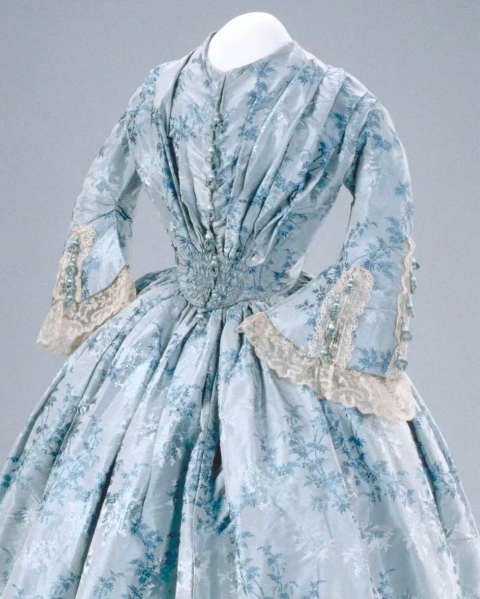 💙 &ldquo;While this dress shows typical design and construction of the 1840&rsquo;s (e.g., piped waistline, front fastenings of hooks and eyelet holes) there is evidence that the material had been used previously. It may be that the silk fabric was 