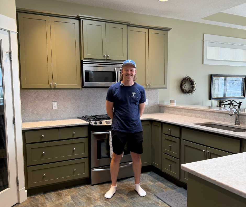 Completed kitchen cabinet refinishing in Vernon, BC featuring a modern olive green finish.