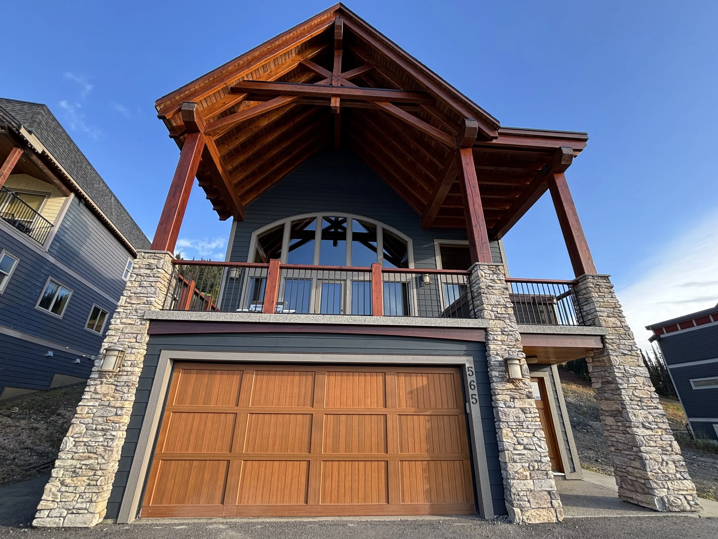 navy-chalet-exterior-painting-with-stained-timber-peak-on-silverstar-home
