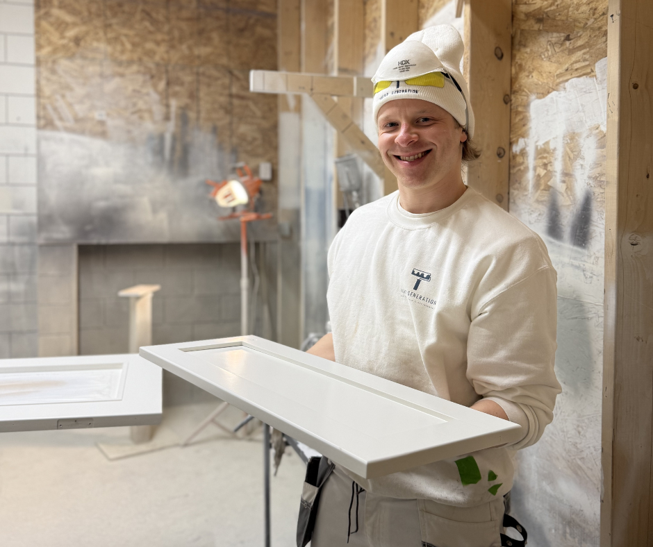 Owner Brook spraying cabinet doors at our Downtown Vernon painting shop.