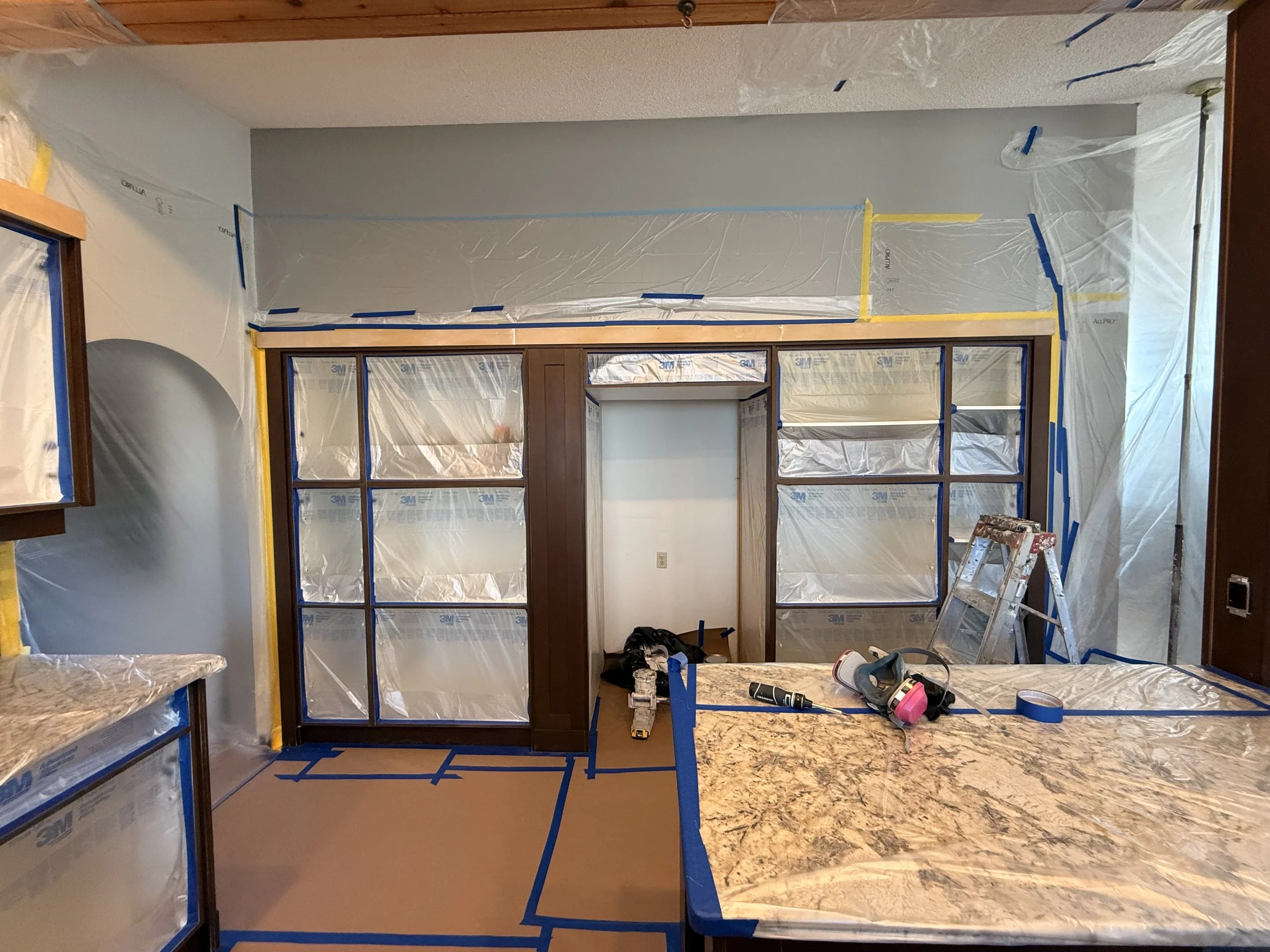 Masking a kitchen before spraying the cabinets