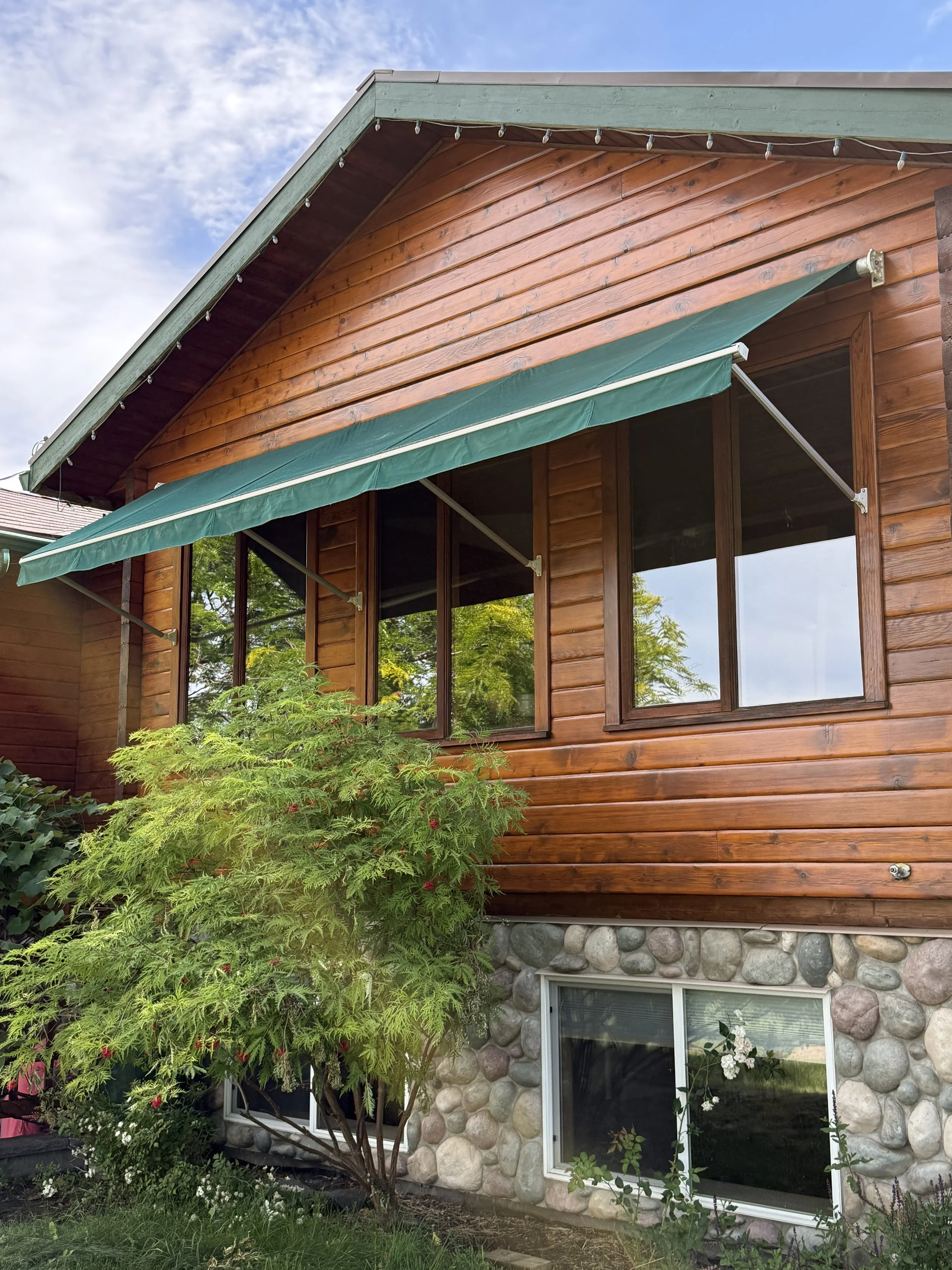 cedar-siding-restoration-and-wood-stain-on-vernon-bc-home-with-stone-foundation