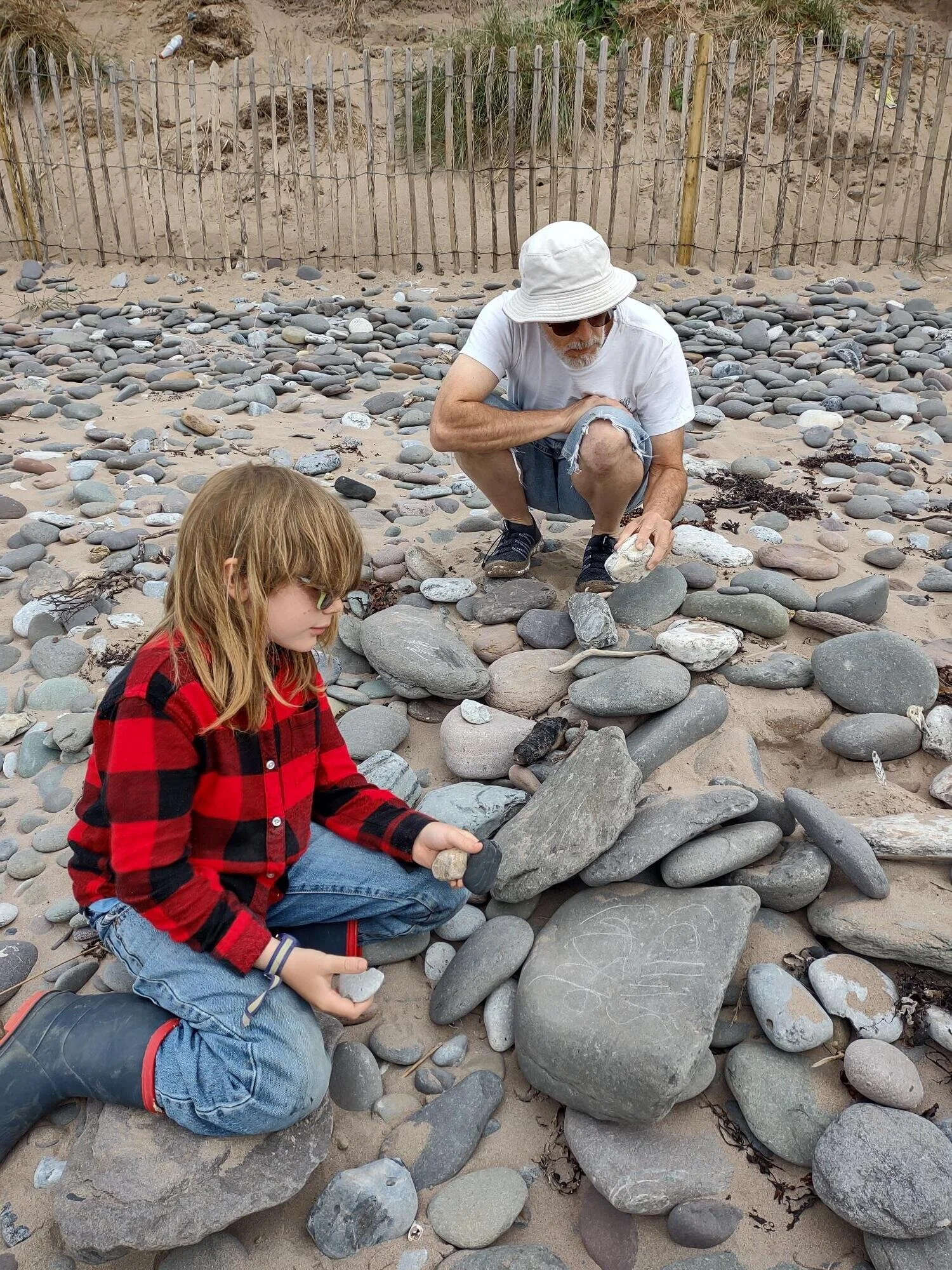 Testing rocks for hardness by writing with them.