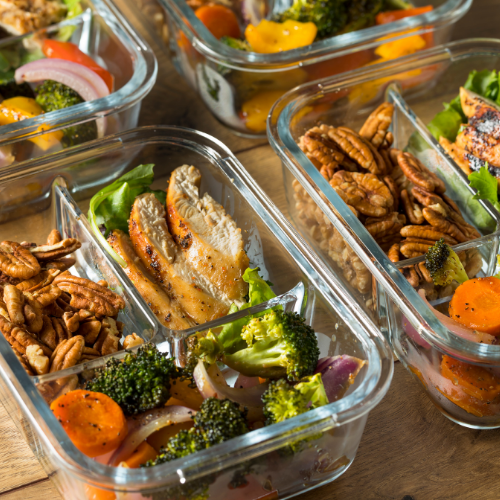 A salad served in a glass food storage containers