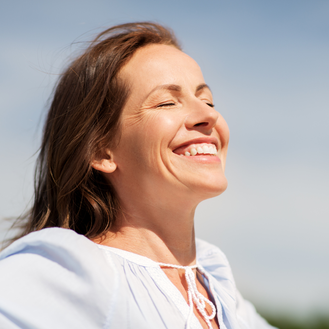 A woman smiling with a sense of freedom and ease