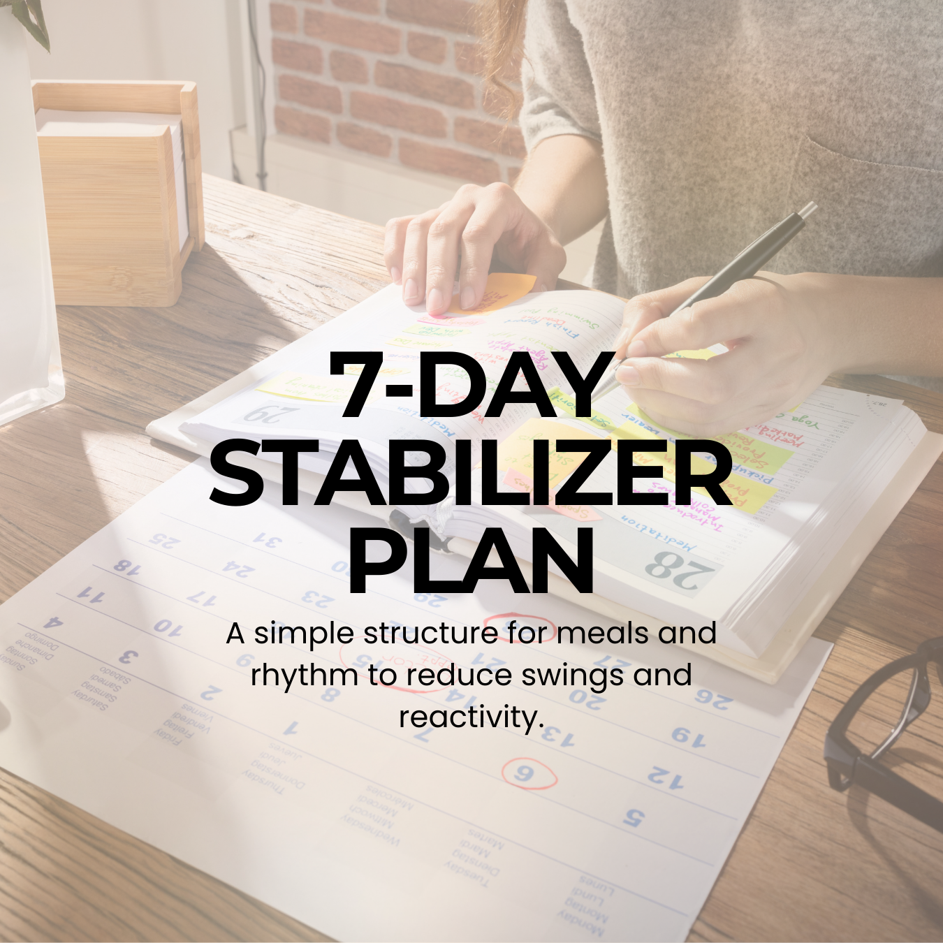 The cover of the 7-Day Stabilizer Plan featuring a woman writing in a notebook at a table with a calendar as she plans her schedule