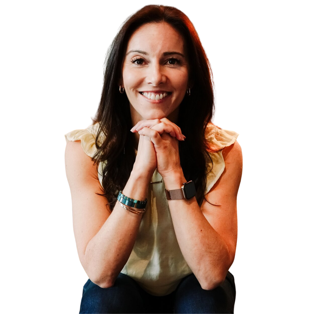 Amanda Hinman sitting on a couch and smiling in a headshot portrait