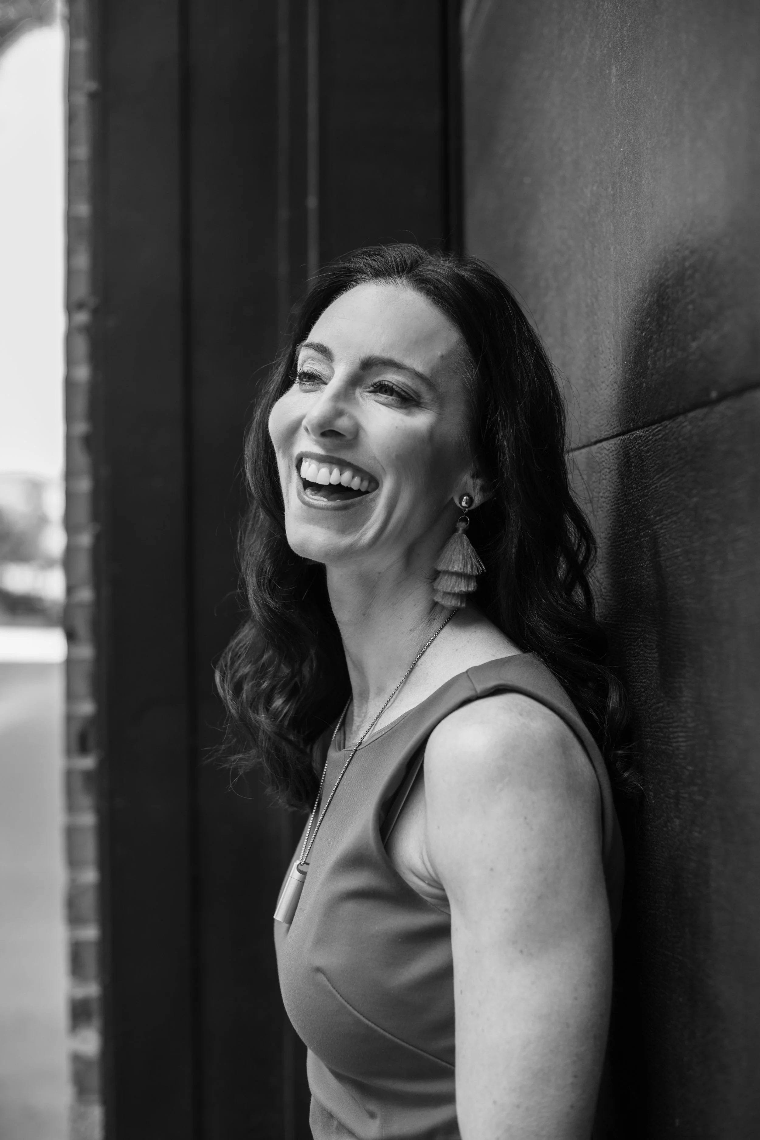 Amanda Hinman black-and-white side profile headshot, smiling