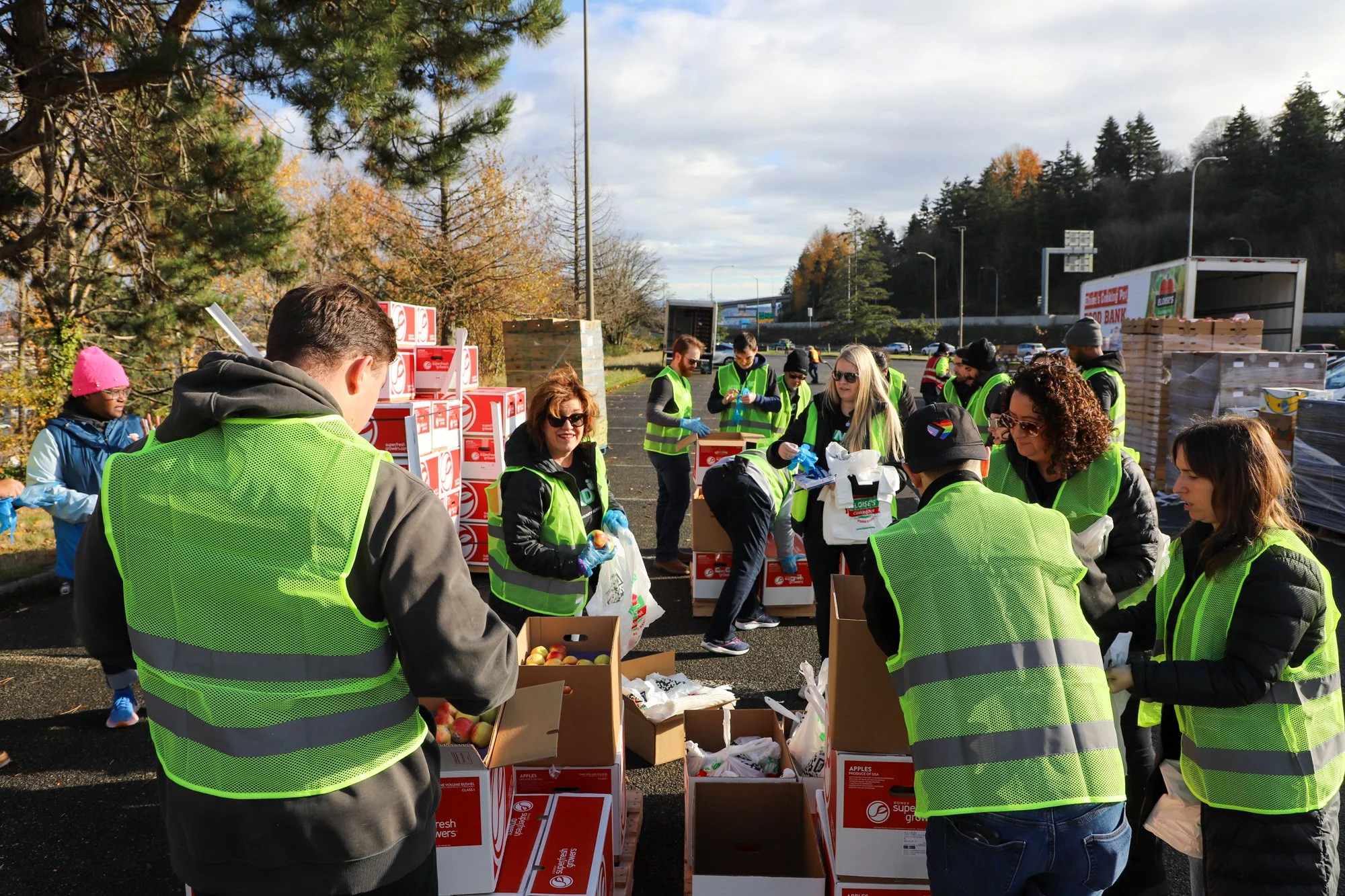 Photo of volunteers packing fruits in plastic bag at Eloise's Cooking Pot