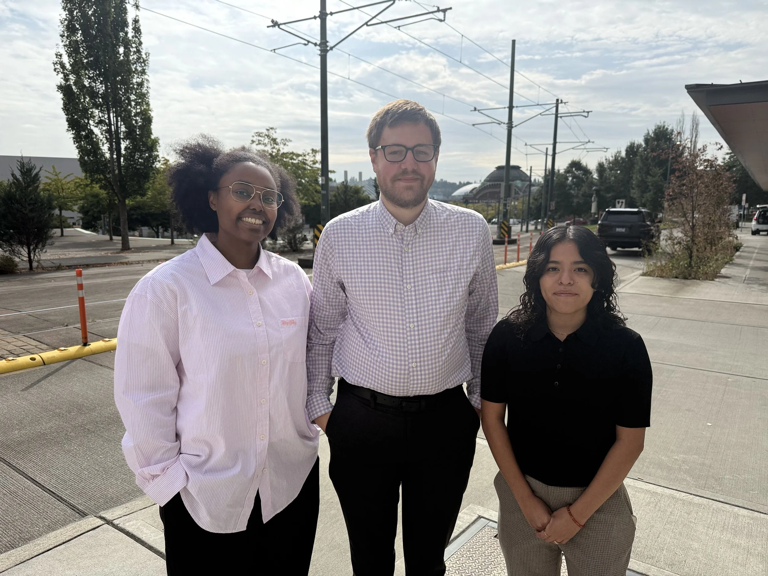 Photo of interns posing in front of Downtown Tacoma landscape
