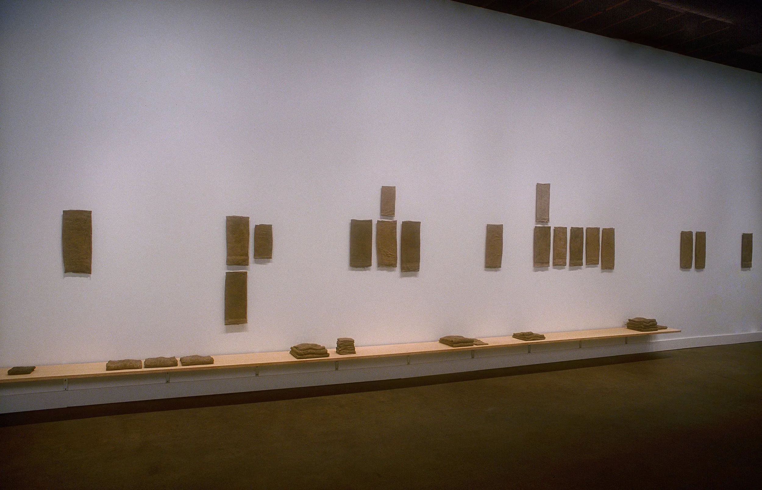   Trace , 2001  used bath & hand towels, wash cloths, earth, plaster, birch plywood size varies