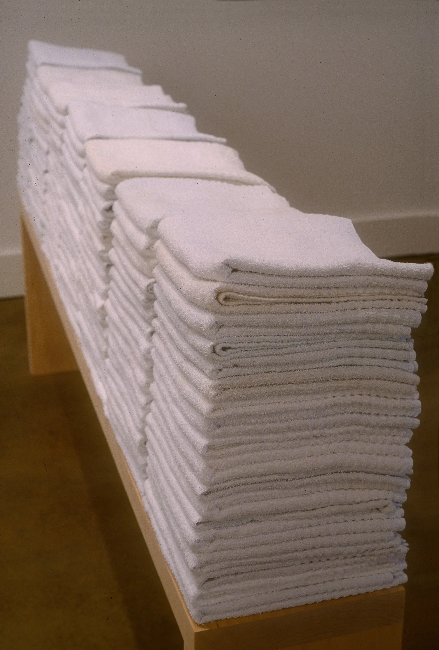   Accretion: Fold, detail , 2001  used terry hospital towels, basswood 72×9×32in approx. each, 5 benches