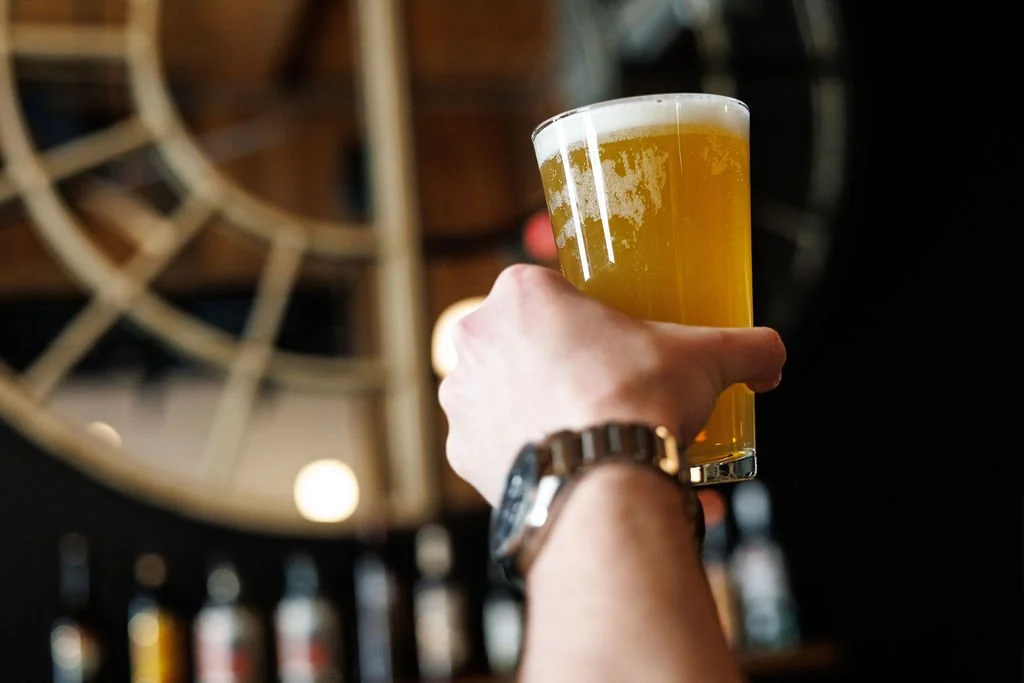 Guest holding a draft beer during a private event at The 801 featuring Street Portsmouth bar packages and cocktail service in Portsmouth, NH