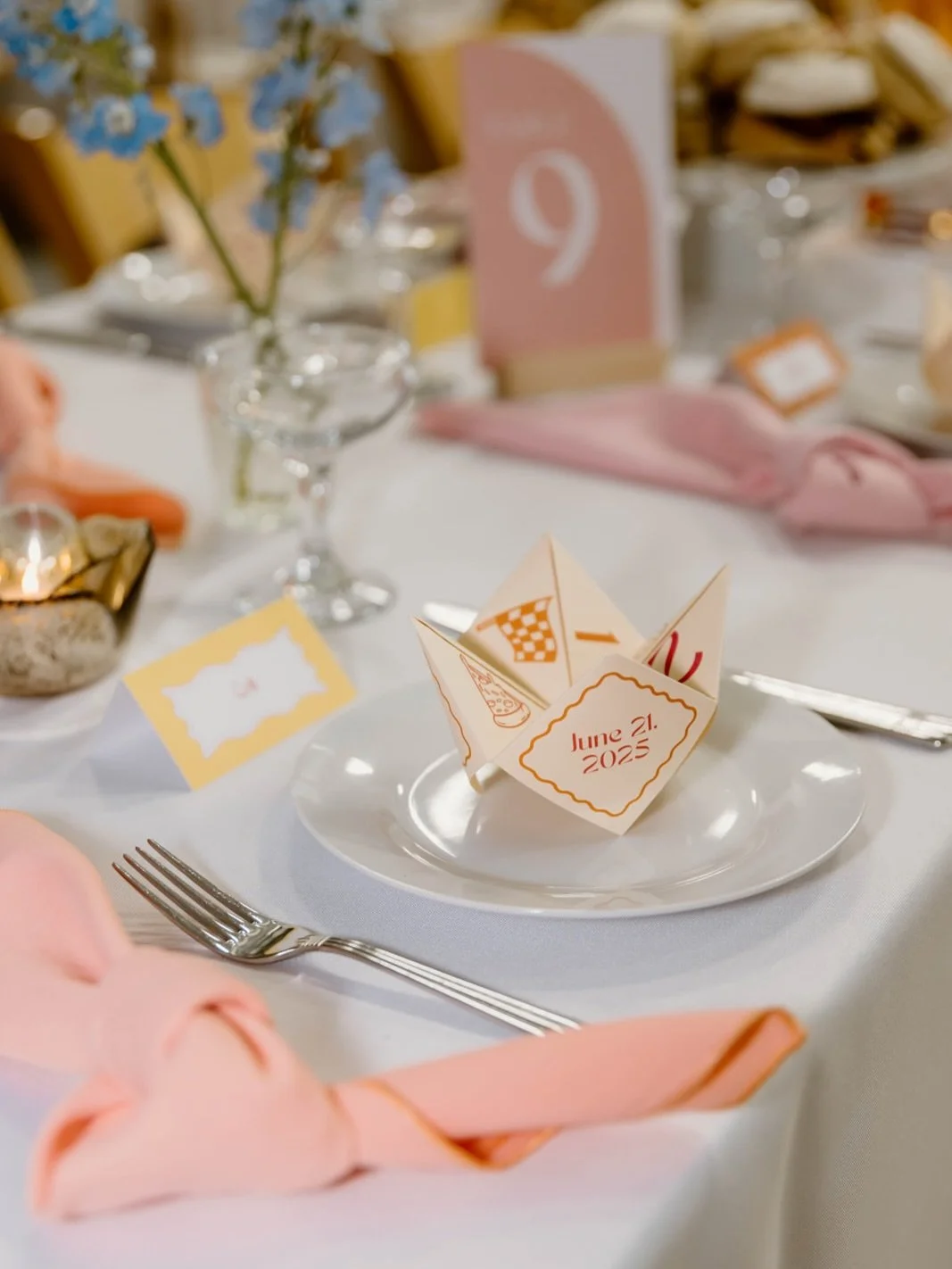 Playful, nostalgic, and full of heart ✨

More and more couples are choosing to design weddings that invite guests to play, linger, and feel at home.

A cootie-catcher at each place setting sparks conversation before dinner even begins.
Vintage badmin