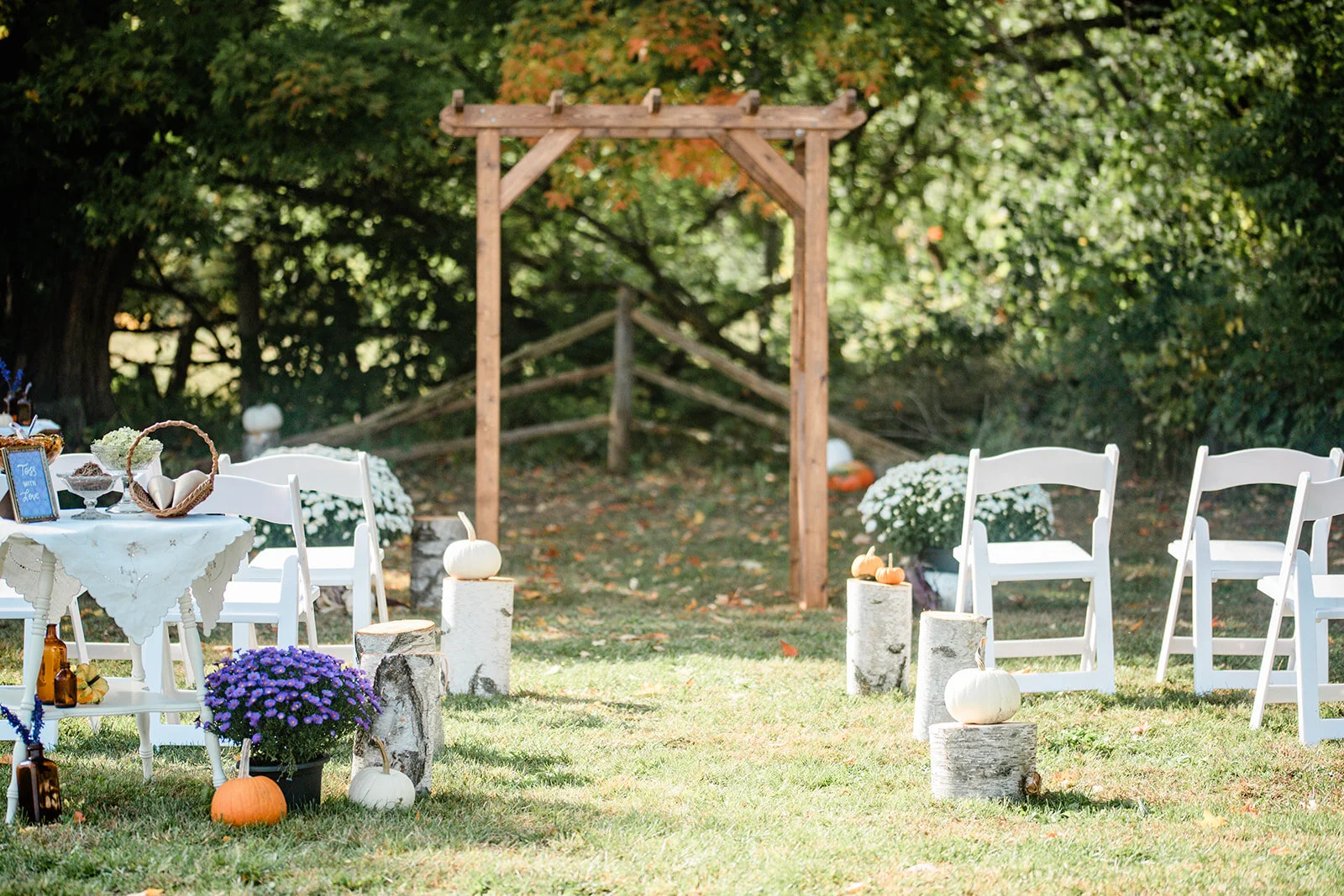 wooden wedding arch in an outdoor fall setting